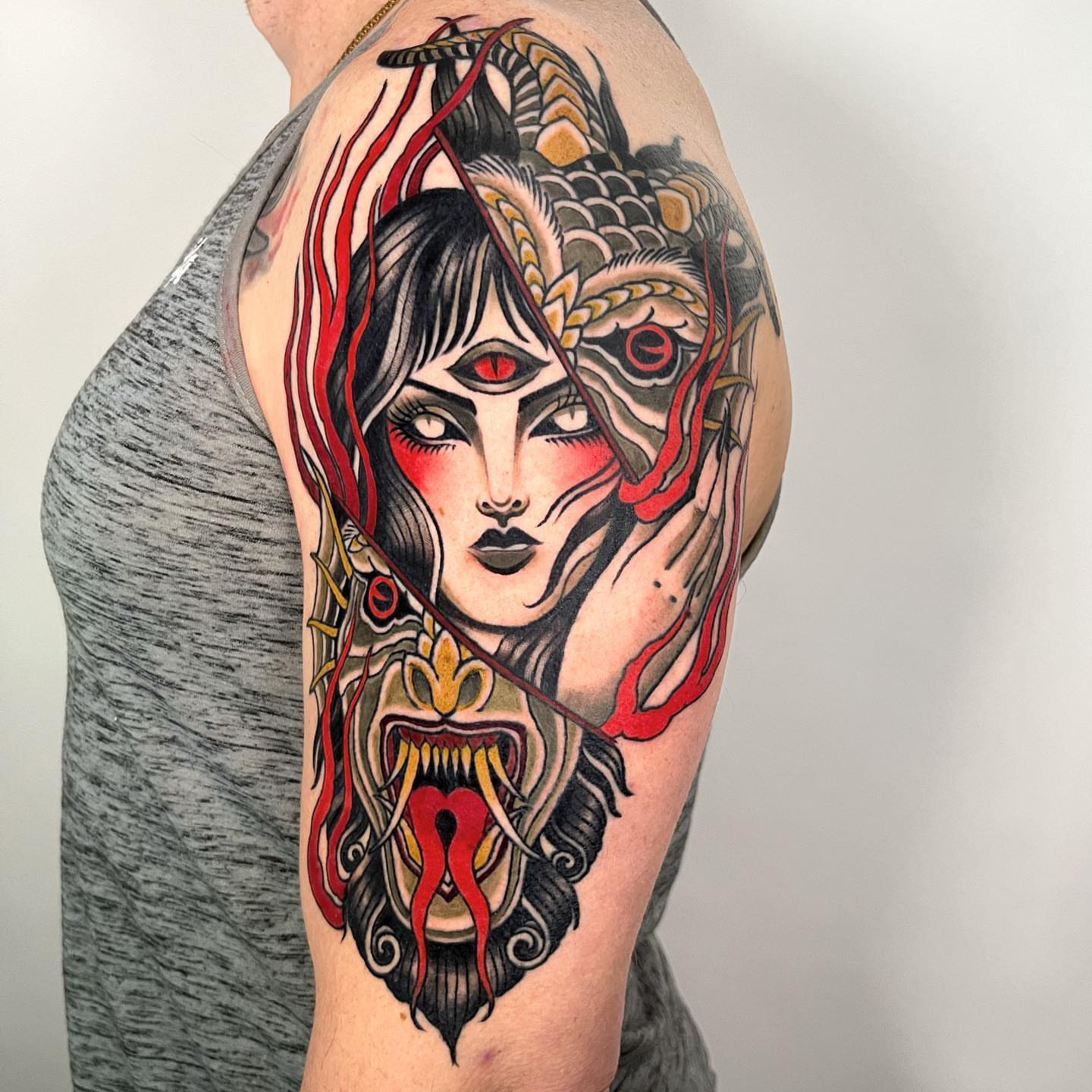 Woman with dragon American traditional tattoo on the shoulder by Sara Lewis