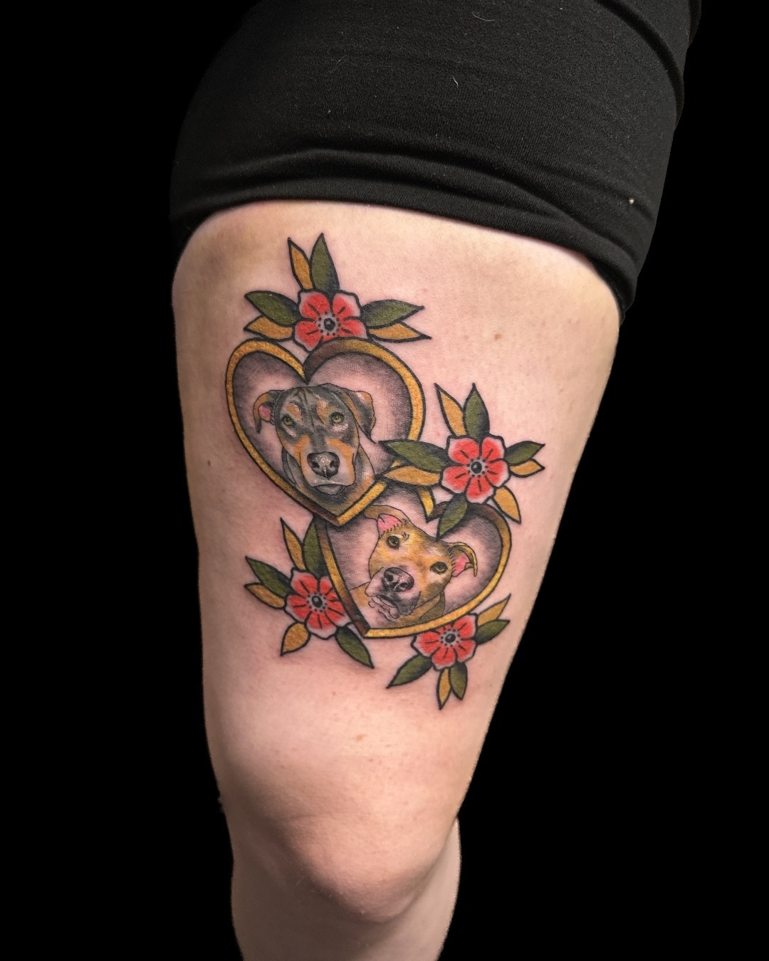 Dogs in heart American traditional tattoo on the thigh by Blake Owens, Nashville, Tennessee