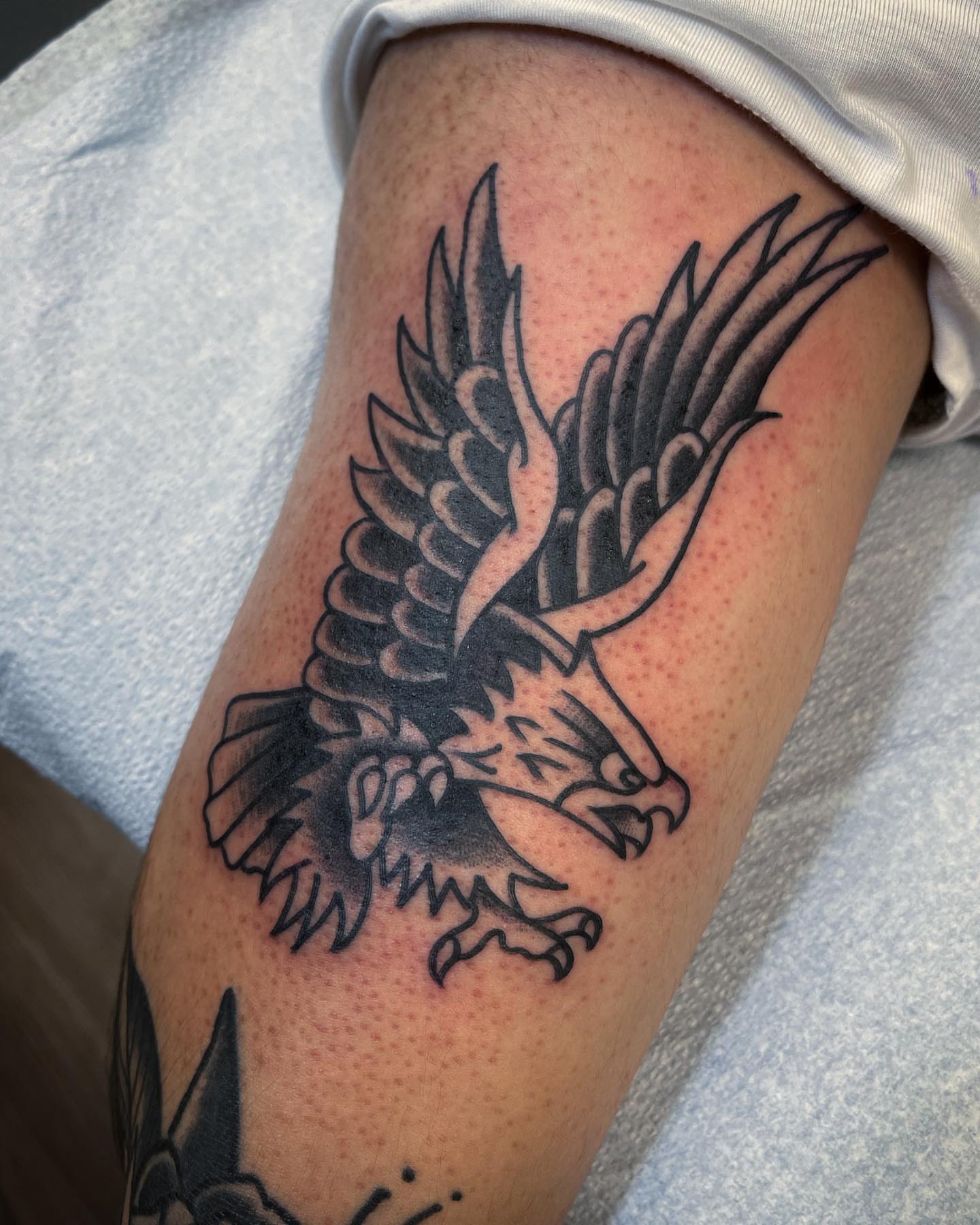 Eagle American traditional tattoo on the thigh by Dave Shurman