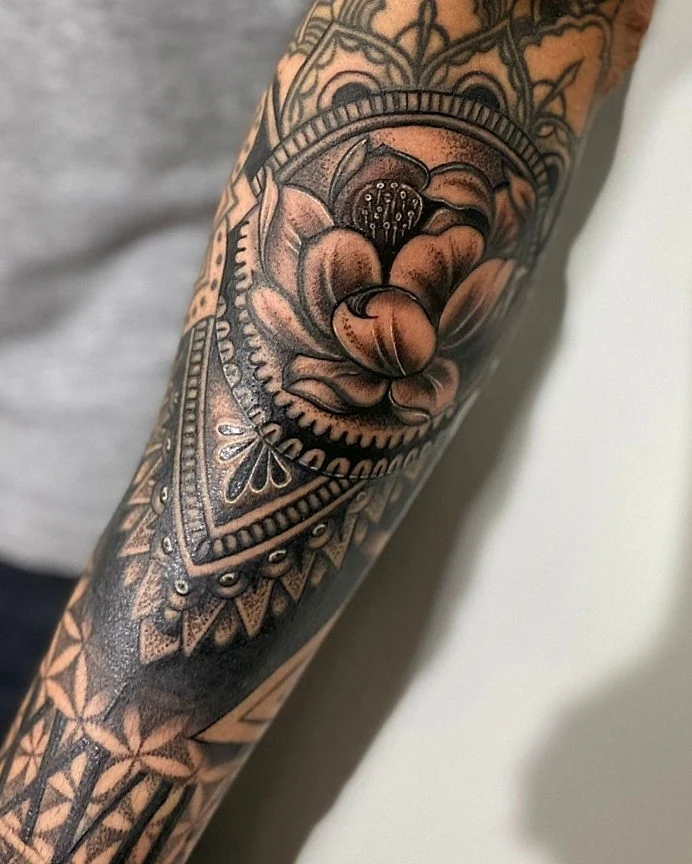 Lotus flower geometric tattoo on the forearm by William Gualteros