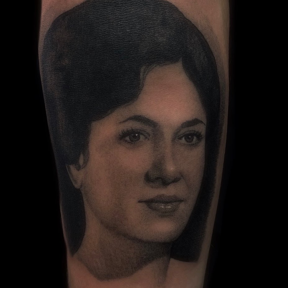 Portrait realism tattoo on the forearm by Justin Hendrick