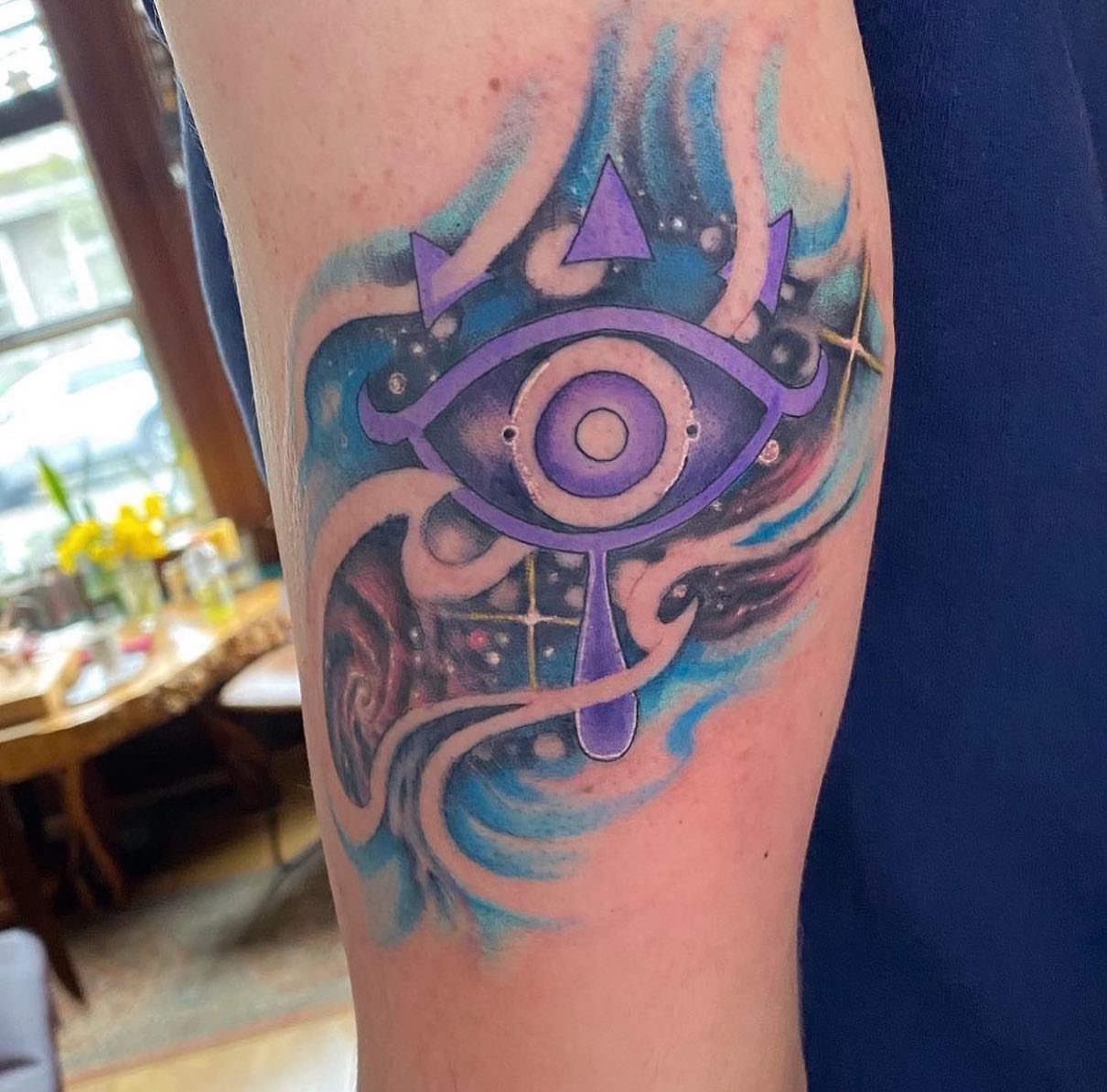 Eye with cosmic background geometric tattoo on the forearm by Shamanic Ink