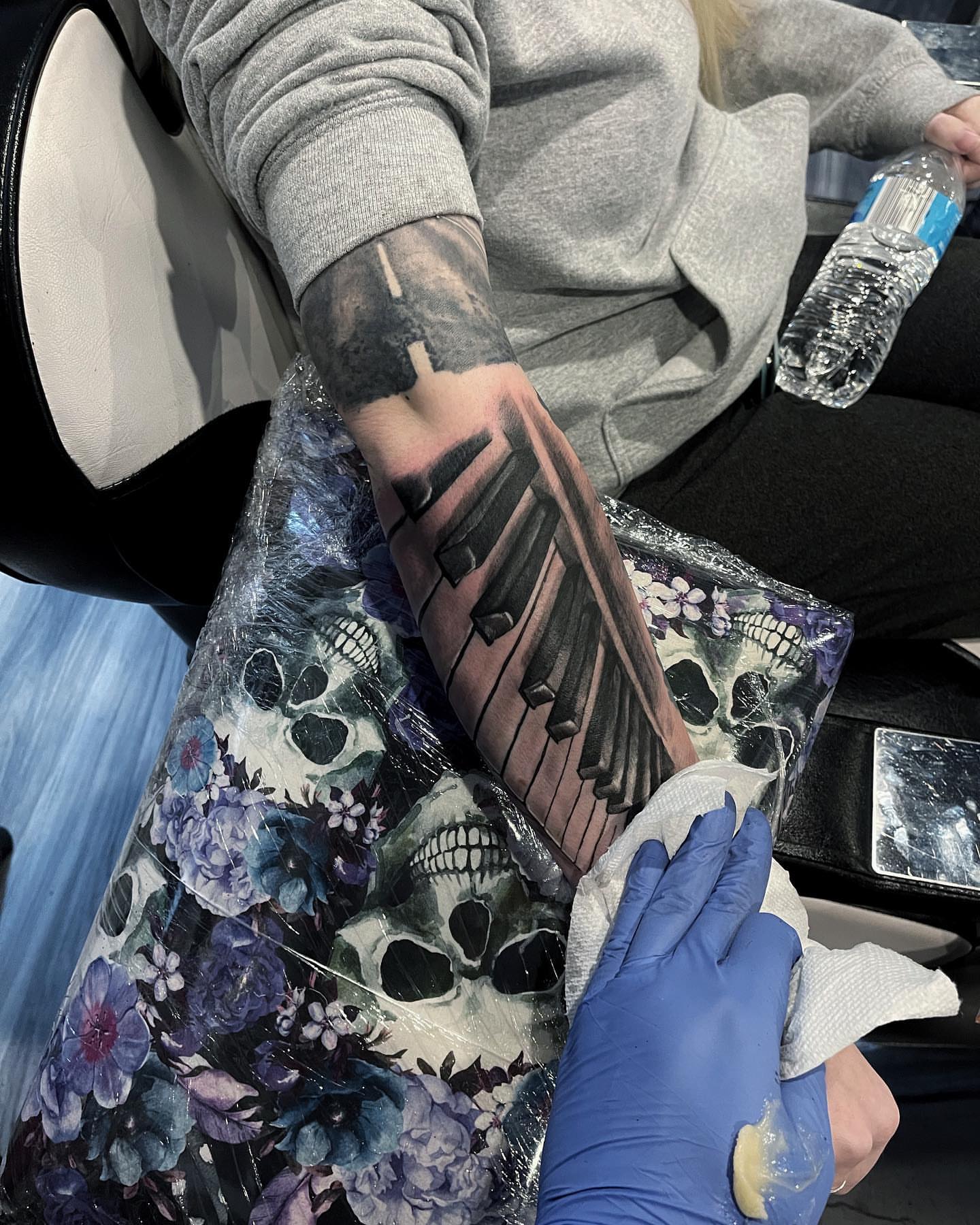Wings and musical notes realism tattoo on the forearm by Antonio Massimino