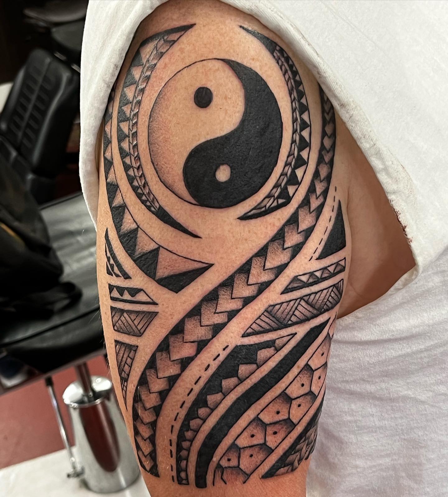 Yin-yang symbol geometric tattoo on the upper arm by IdleHandsFlex, New Orleans, Louisiana