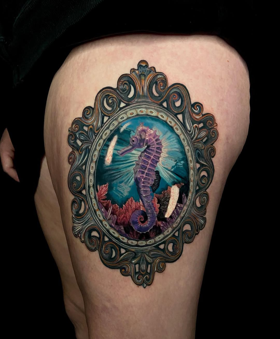 Seahorse in ornate frame surrealism tattoo on the thigh by Jules, Arlington, Texas