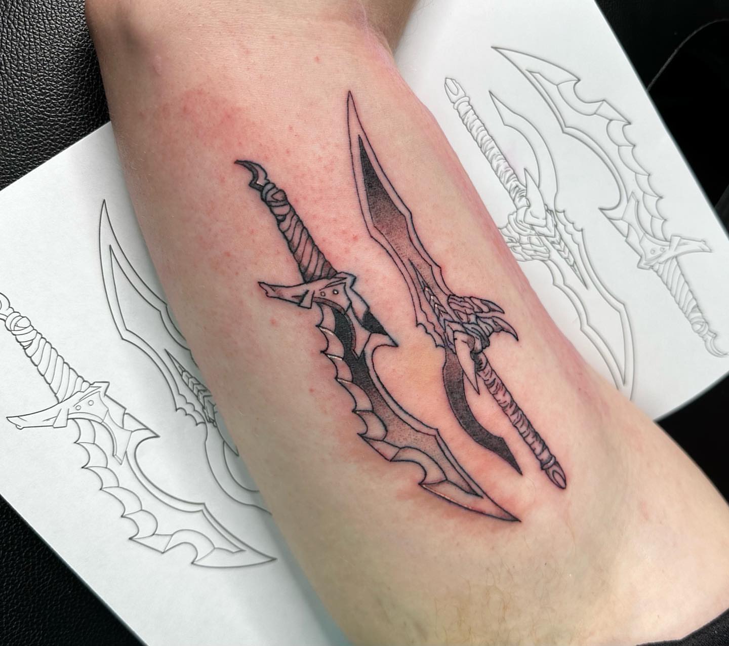 Sword black and grey tattoo on the forearm by V