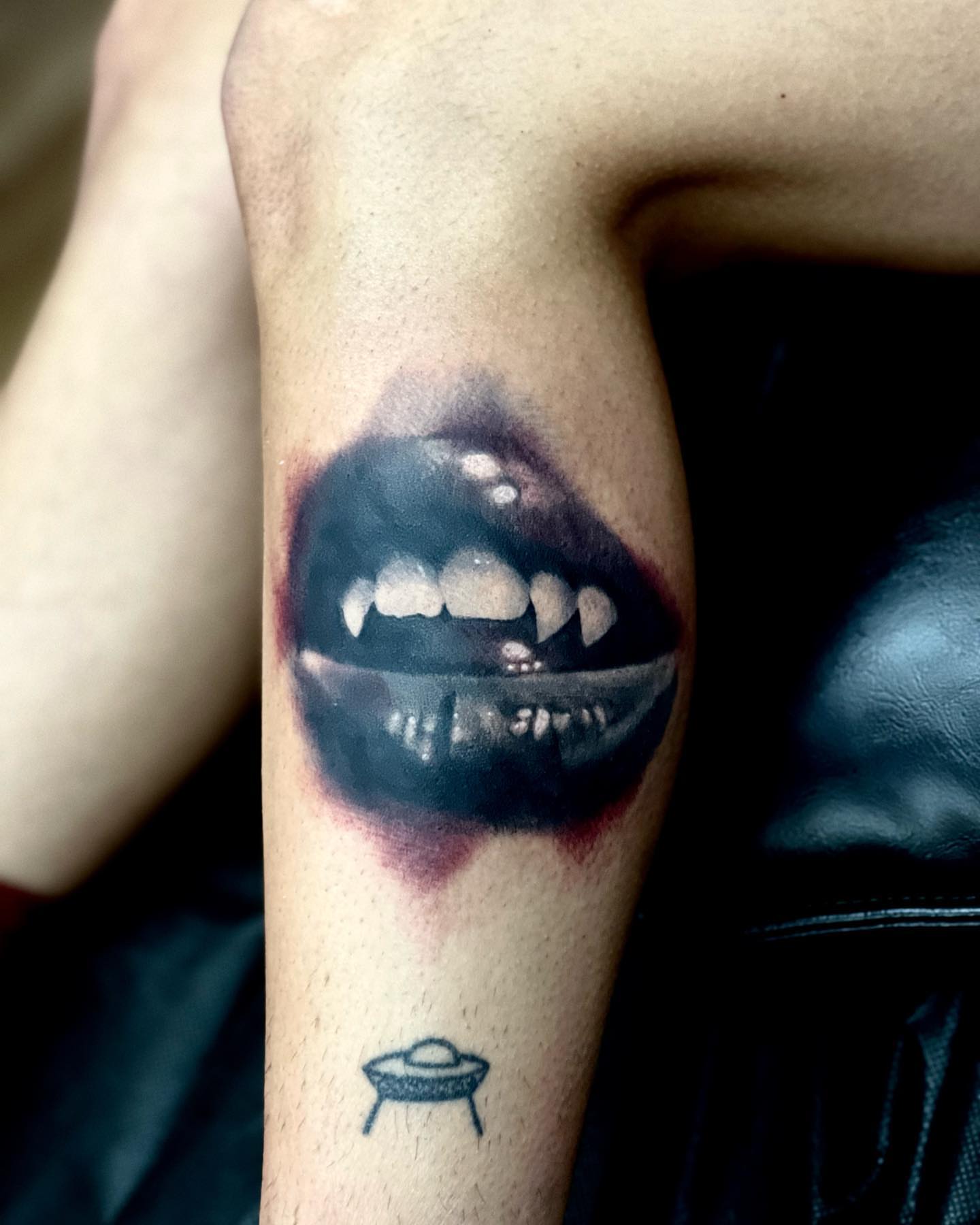 Vampire mouth realism tattoo on the forearm by Travis Thorpe