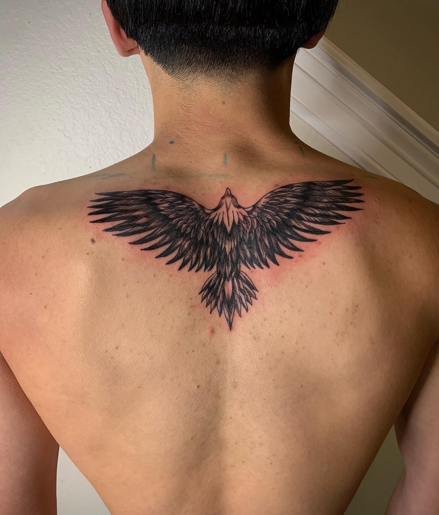 Eagle black and grey tattoo on the back by Leo Torres