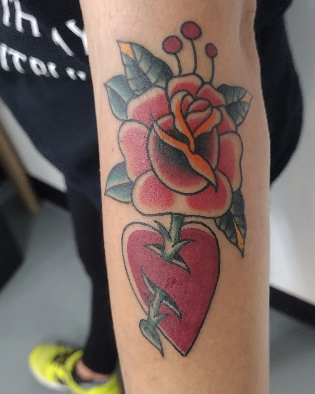 Rose and heart American traditional tattoo on the forearm by Herc