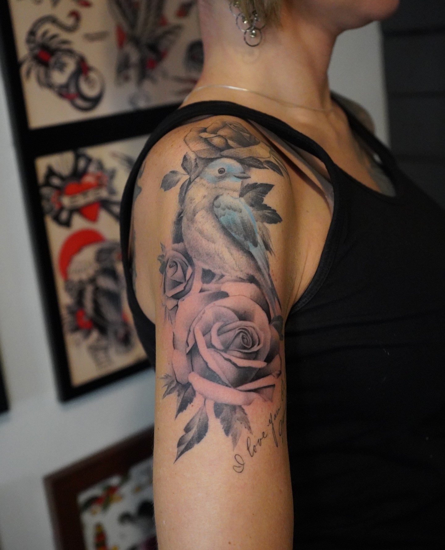 Bird and roses realism tattoo on the upper arm by Danny Madsen