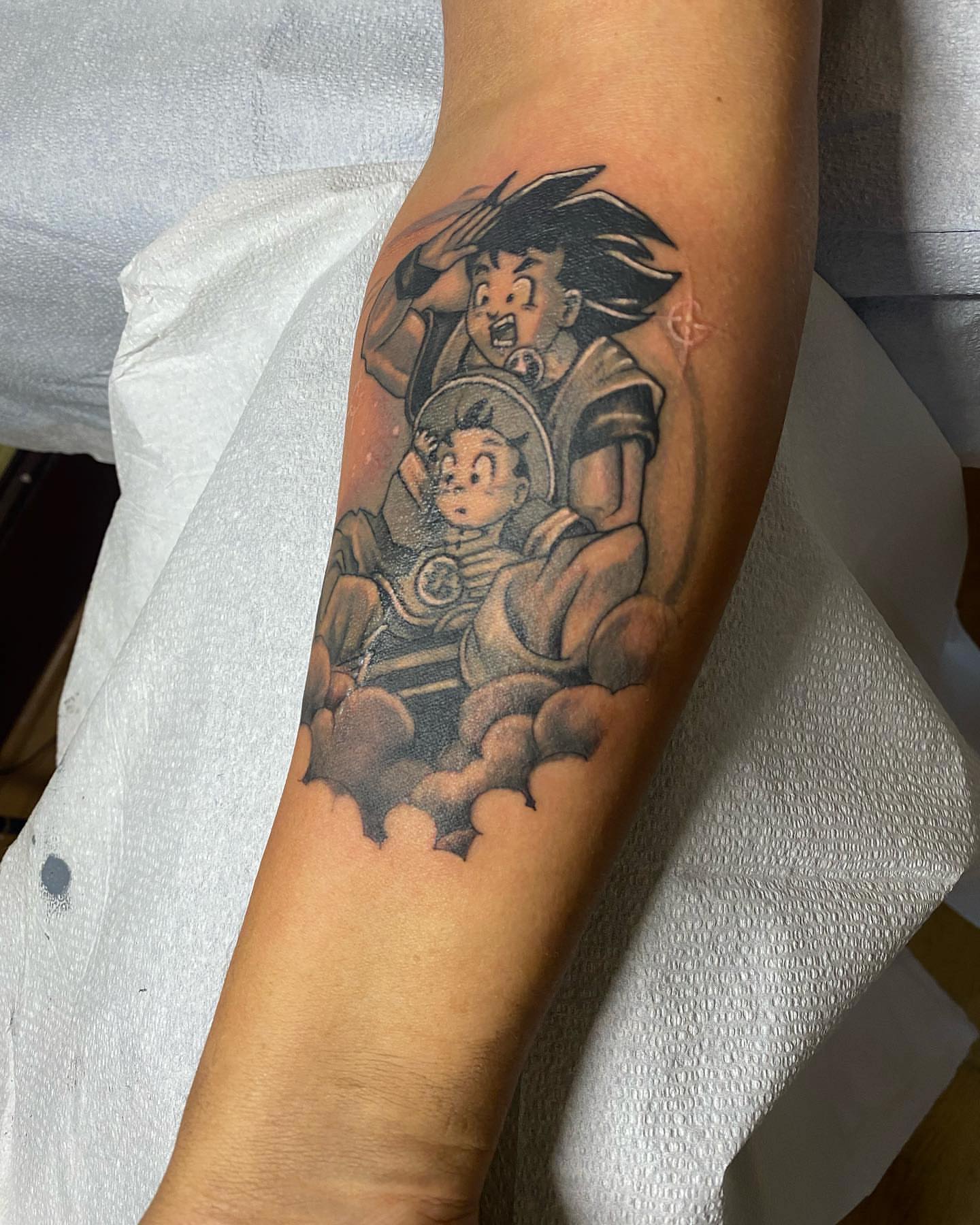 Son goku and son gohan anime tattoo on the forearm by Shamanic Ink