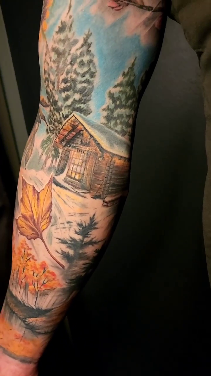 Cabin and trees realism tattoo by Neil Ohmie
