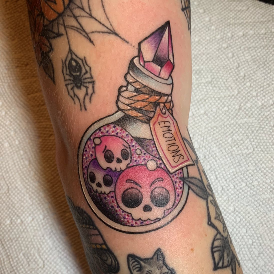 Emotions bottle new school tattoo on the forearm by Brad Sterling