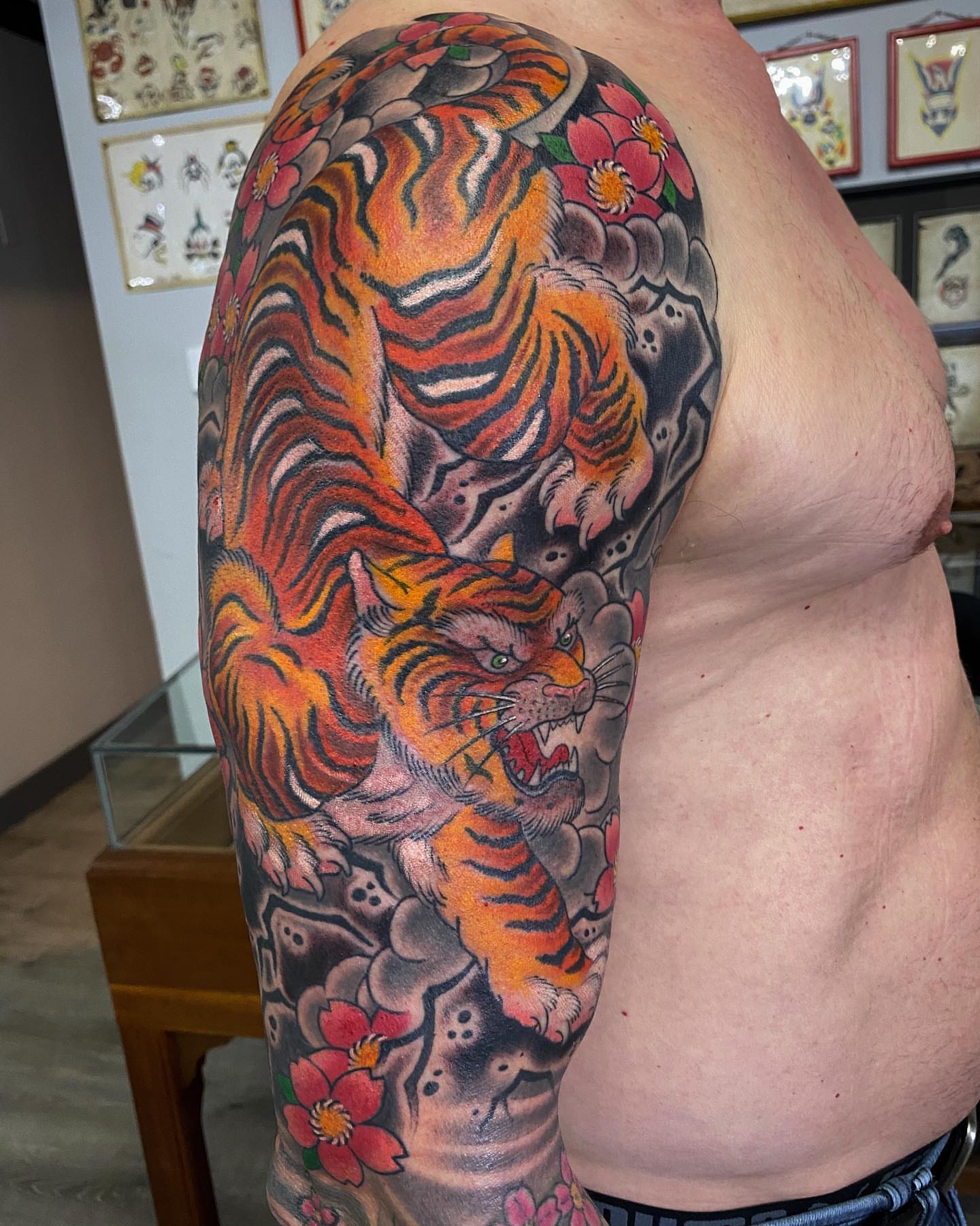 Tiger and flowers japanese irezumi tattoo on the upper arm by Erick Lynch, Cambridge, Massachusetts
