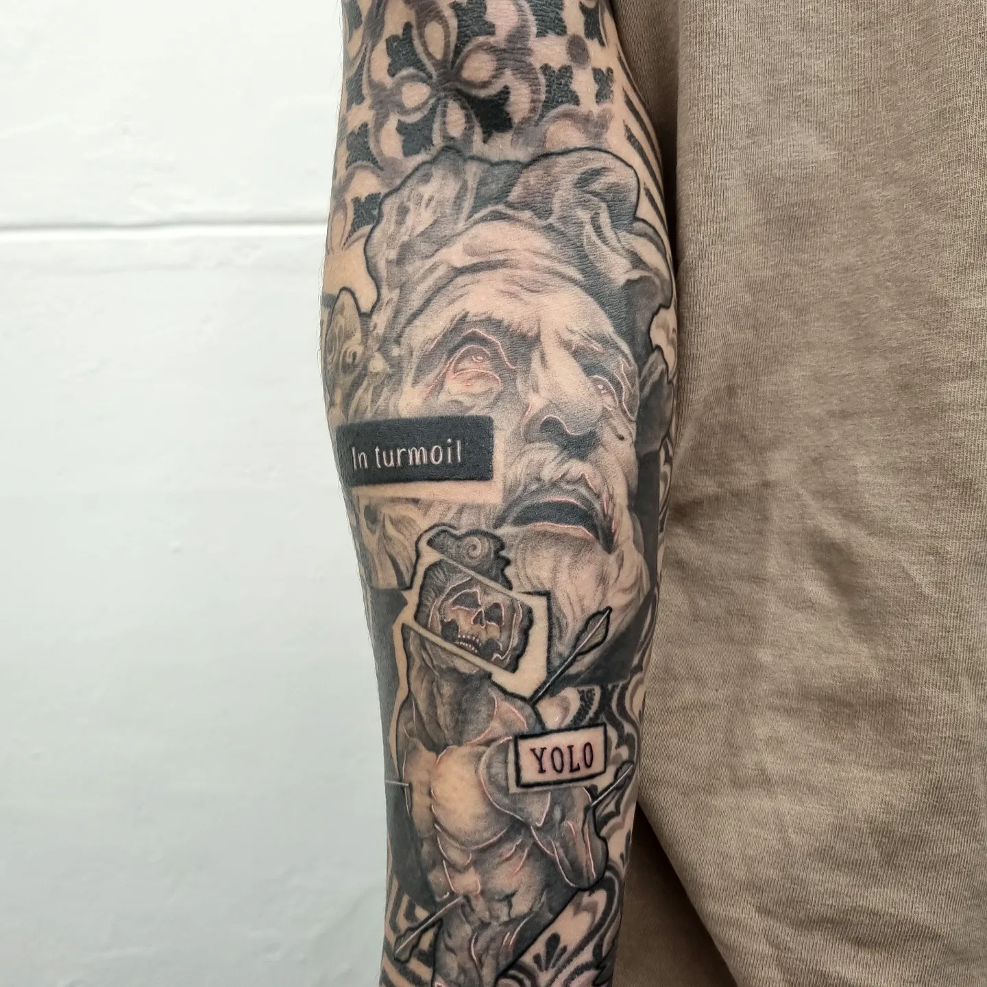 Ancient man with skull realism tattoo on the forearm by Tattooer Hermin 허민