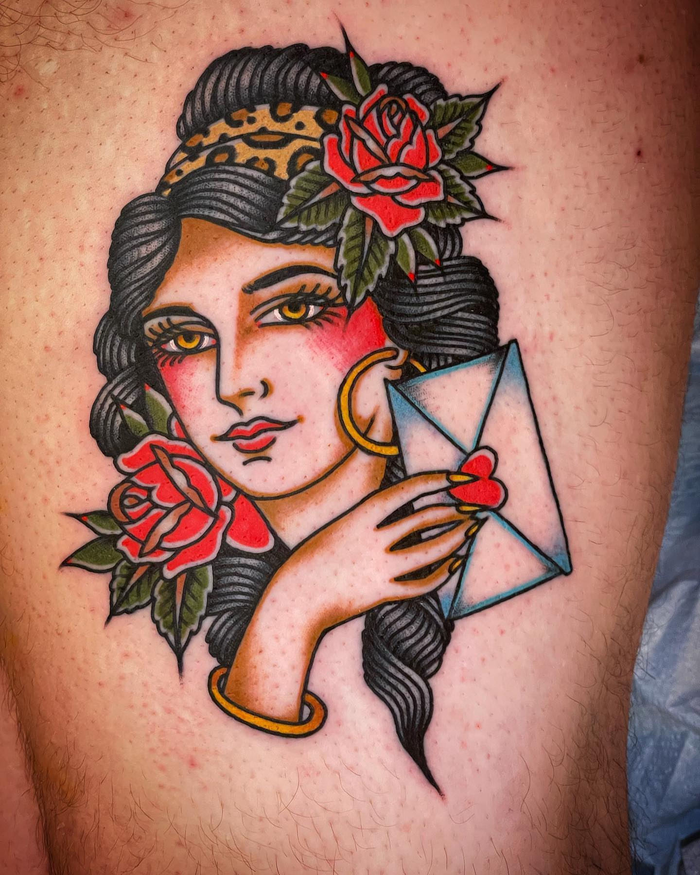 Woman with roses American traditional tattoo on the thigh by Alex Muniz