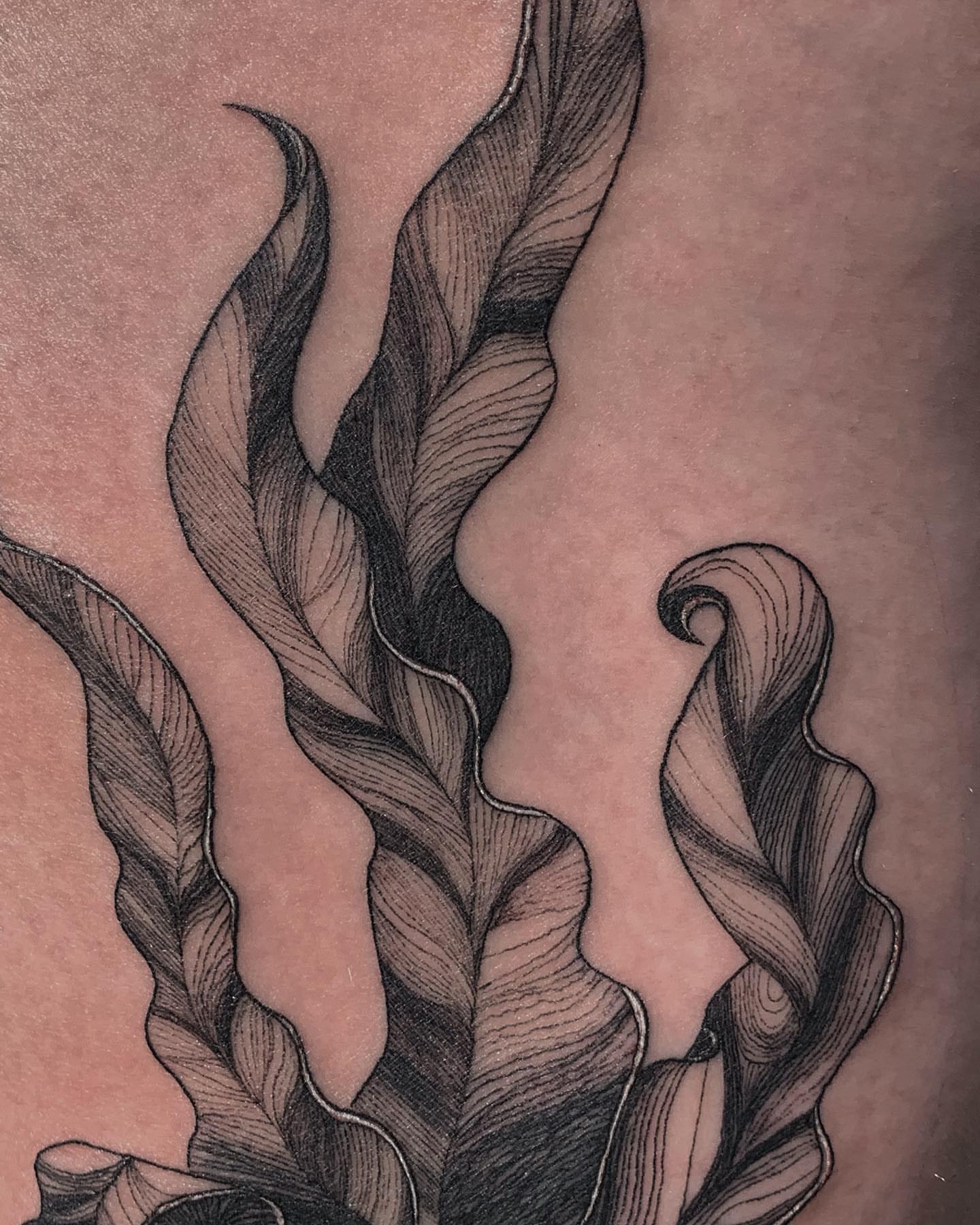 Feather black and grey tattoo on the forearm by Liv