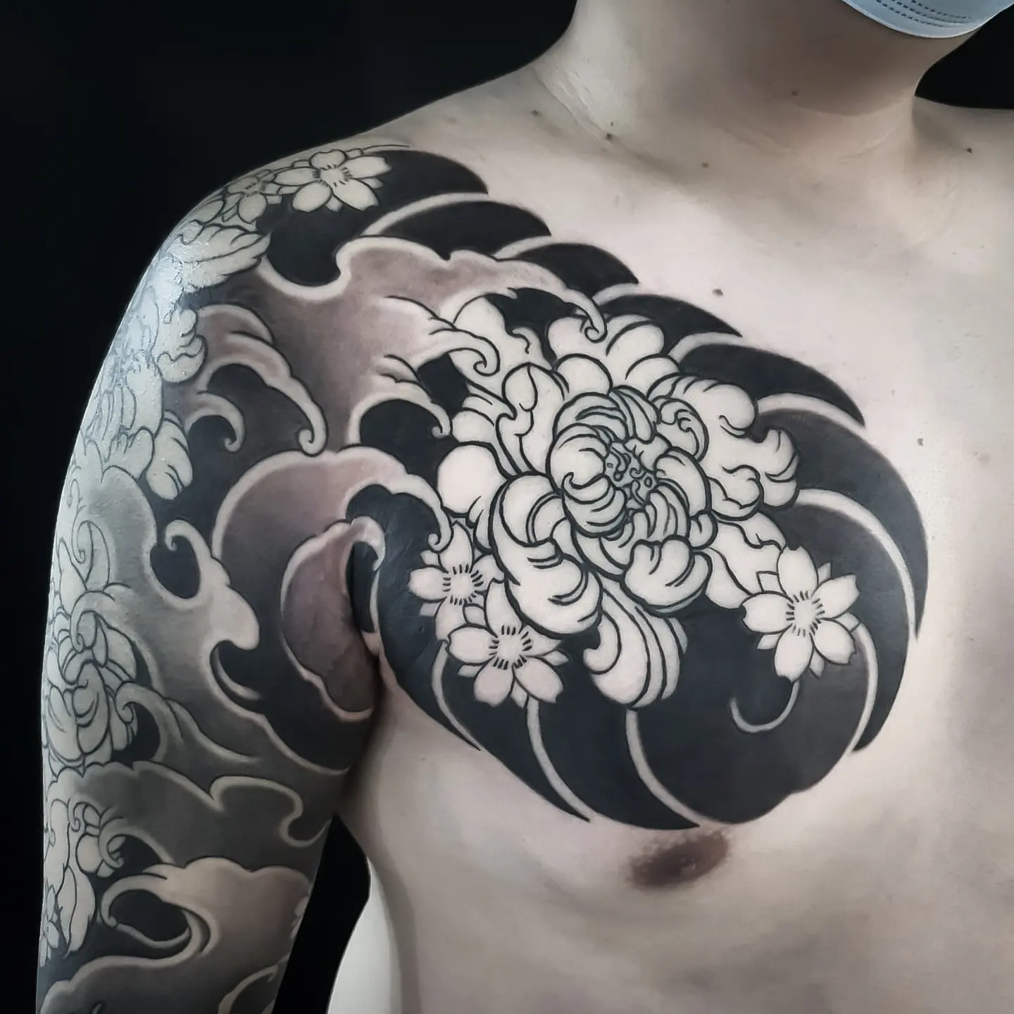 Chrysanthemum black and grey tattoo on the chest by Kubo