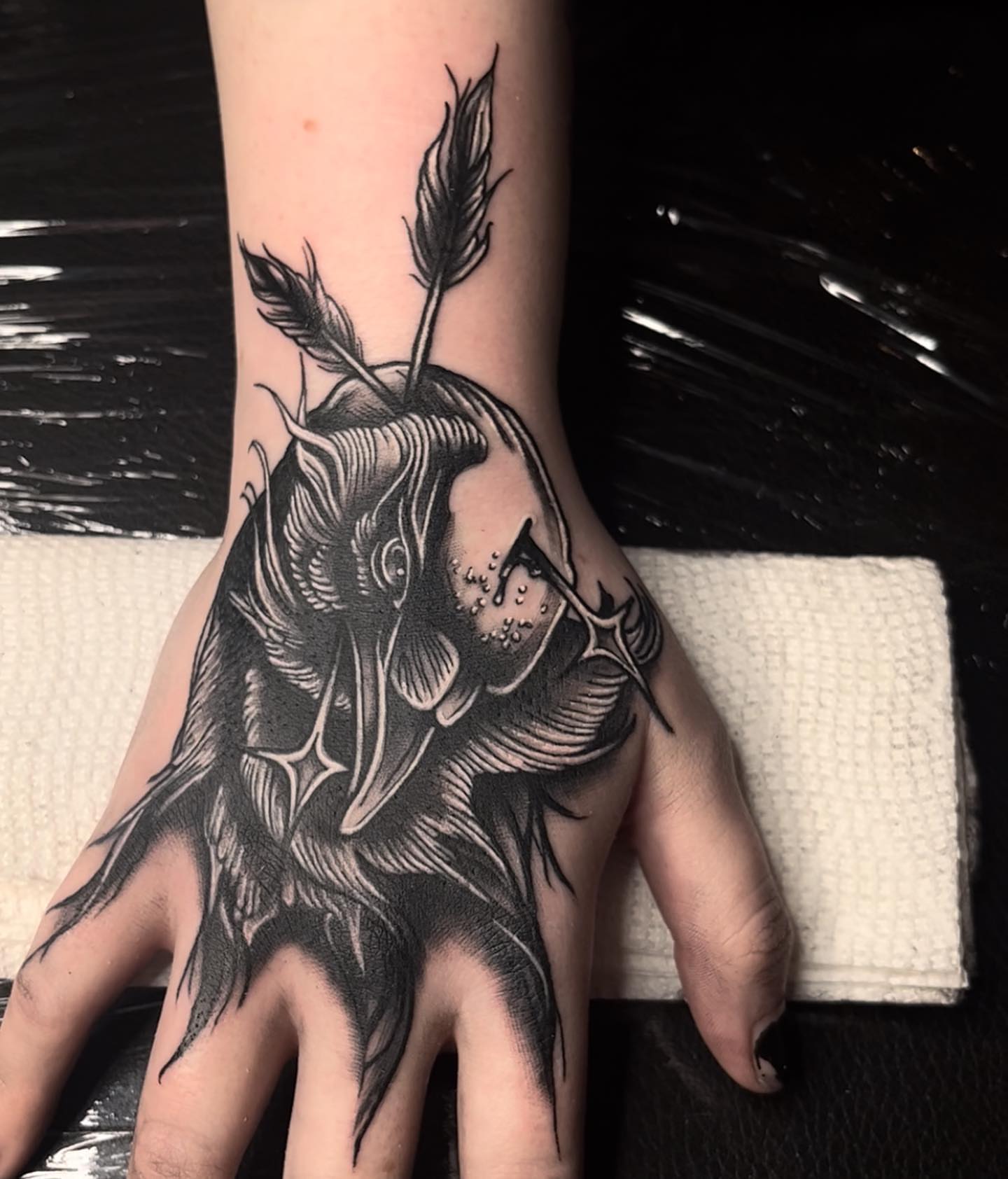 Apple with arrow black and grey tattoo on the hand by Myla Jane, Houston, Texas