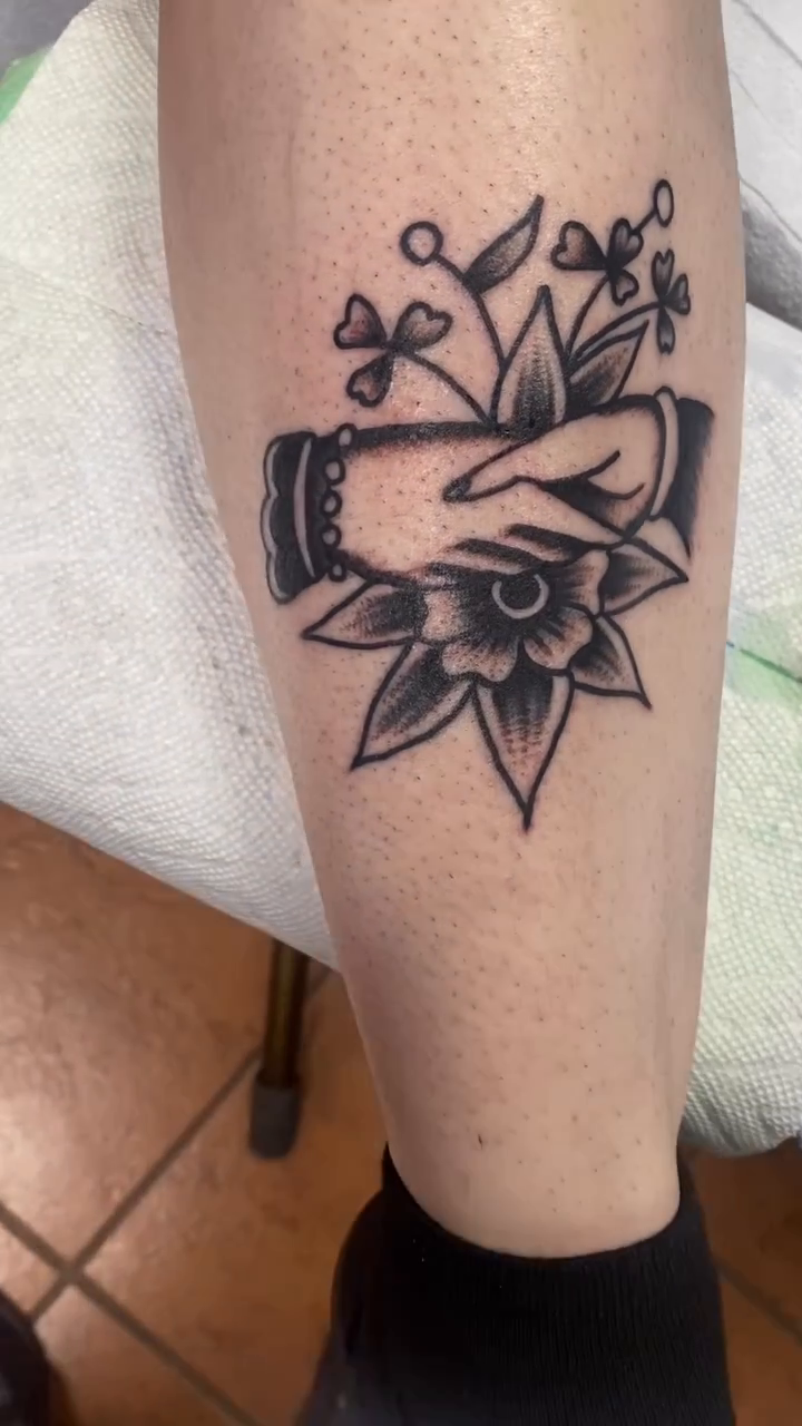Shaking hands with flower American traditional tattoo by Dorian Grey Baker