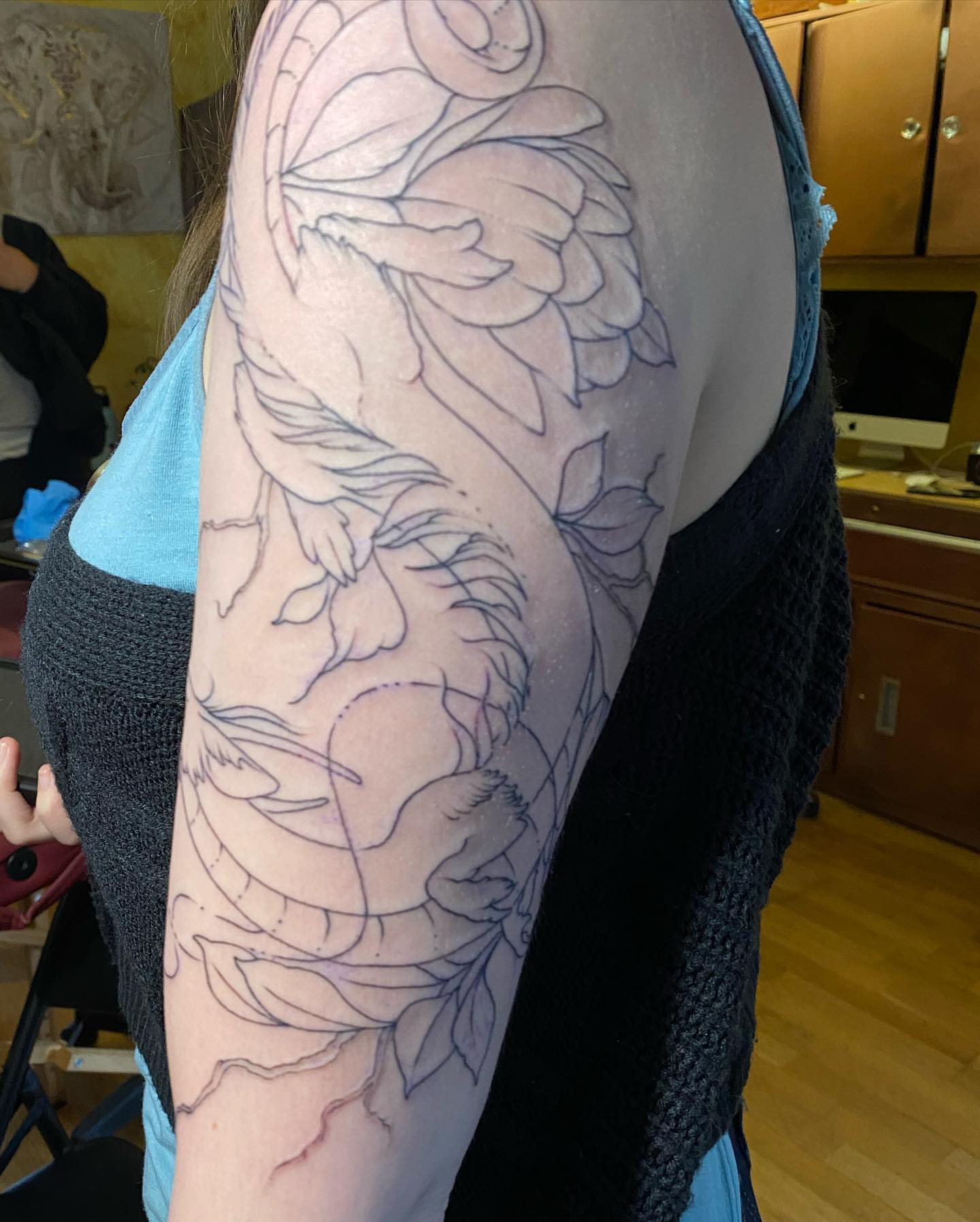 Peony and dragon black and grey tattoo on the upper arm by Shamanic Ink