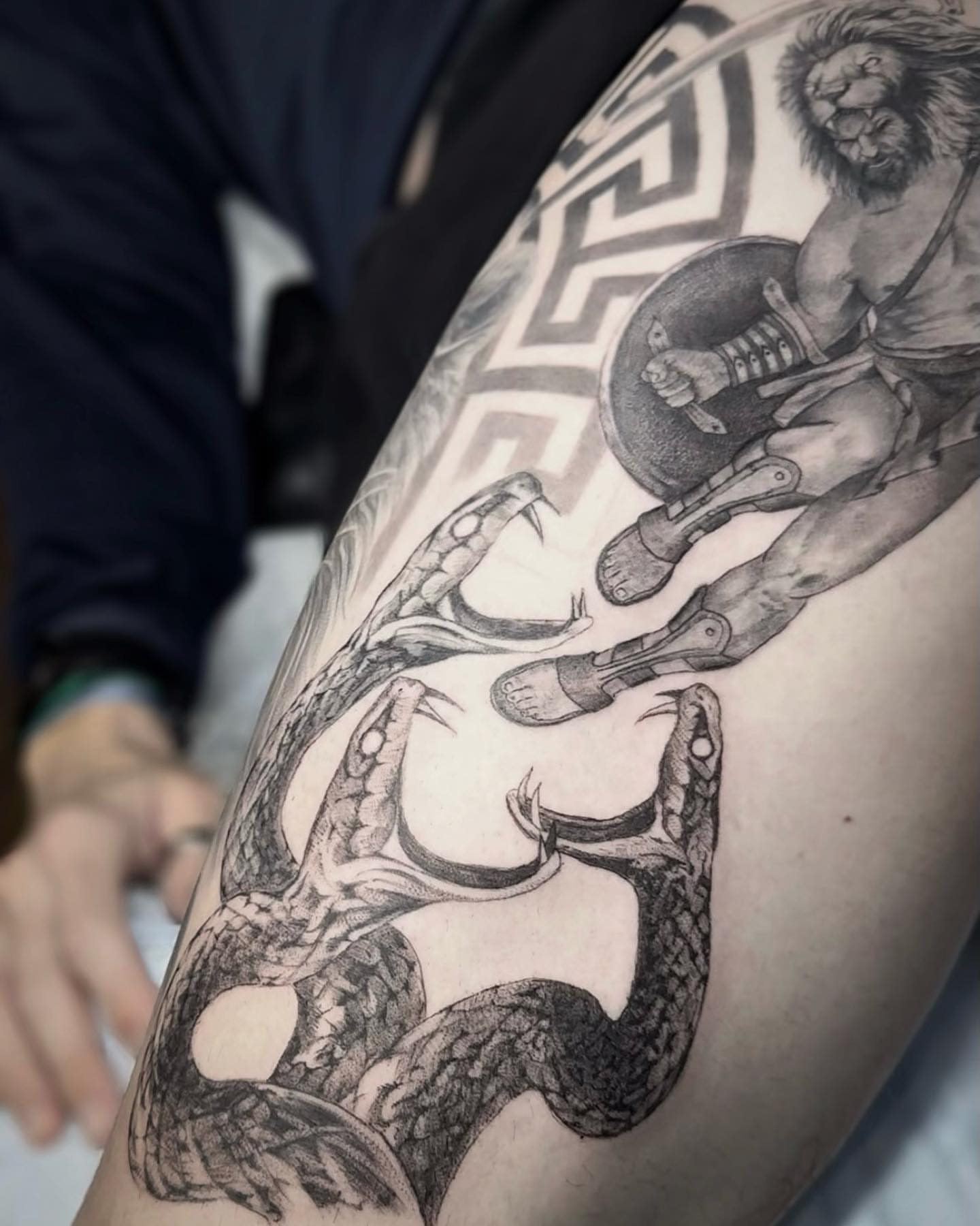 Mythological figure and snake geometric tattoo on the thigh by Oxana