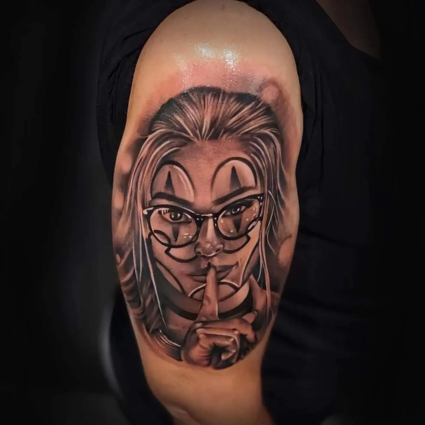 Woman with glasses realism tattoo on the shoulder by Mark Melanson
