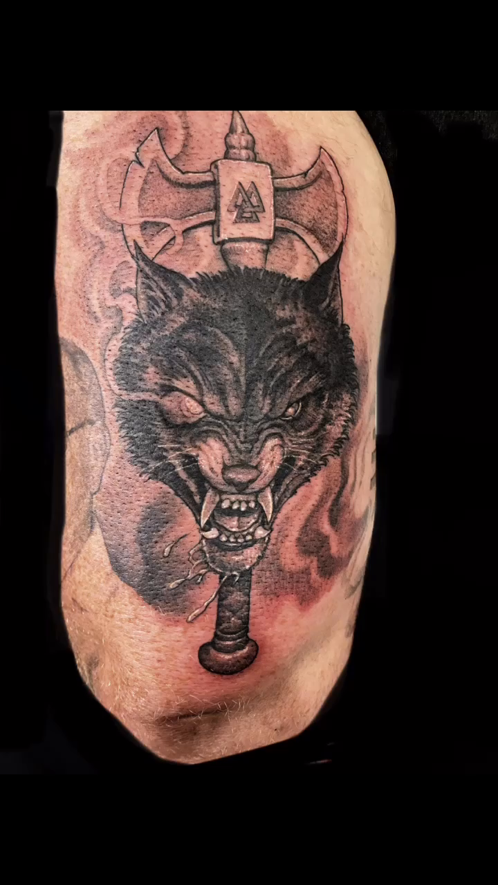 Wolf head with axe realism tattoo by Justin Hendrick