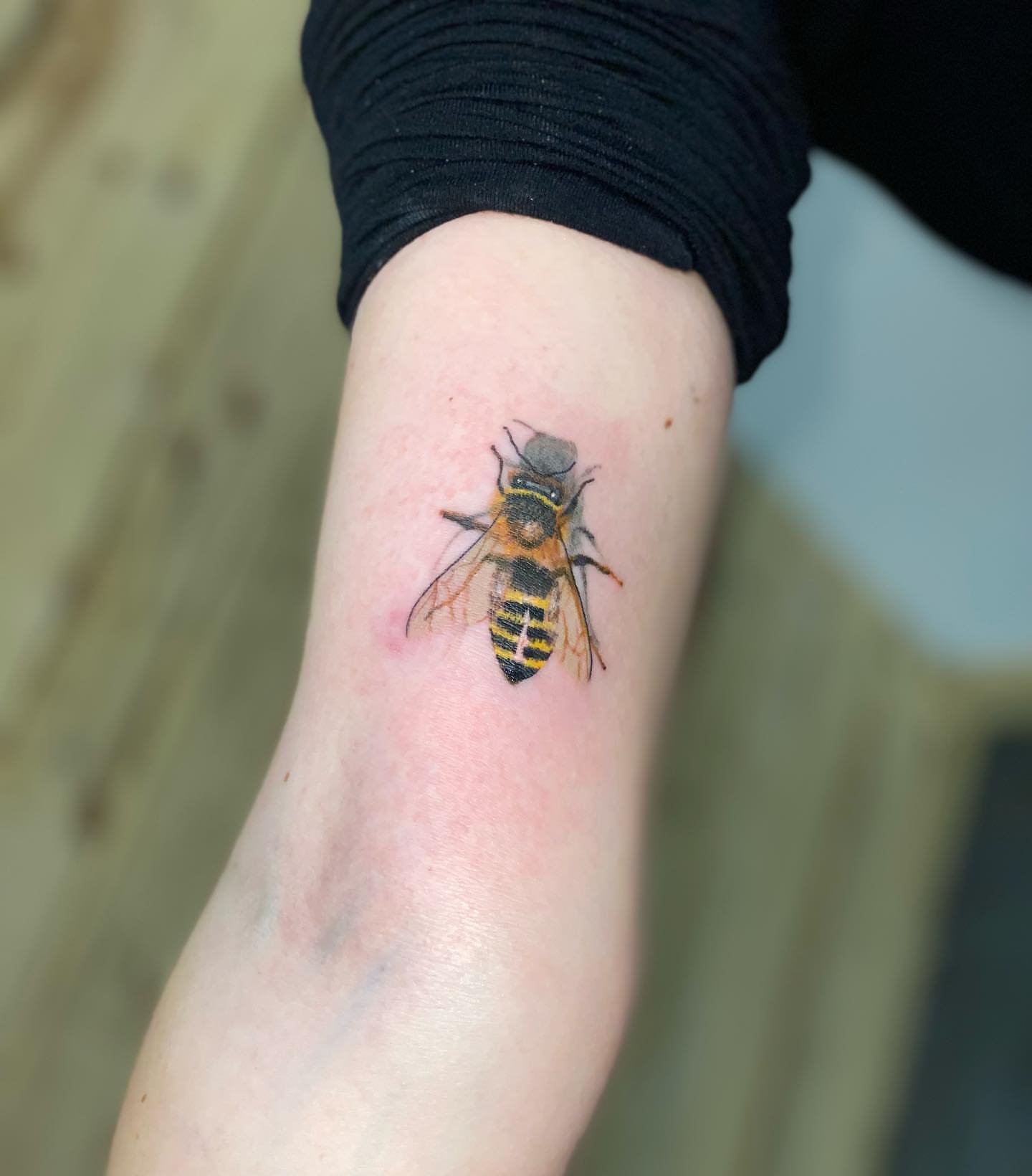 Bee realism tattoo on the forearm by Zach Ashton