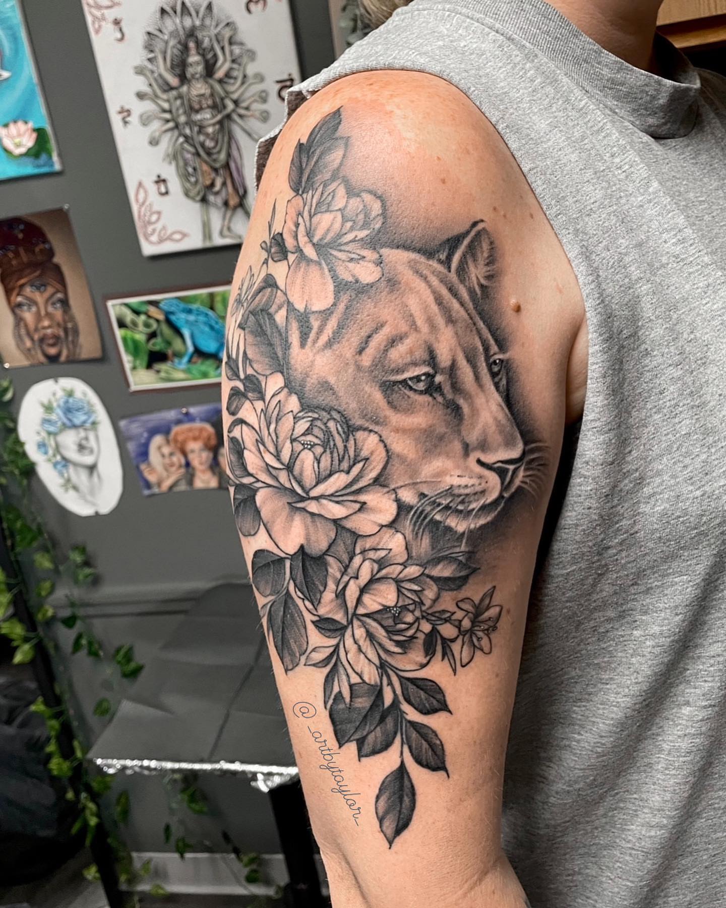 Lion and flowers realism tattoo on the upper arm by Taylor✍🏽️