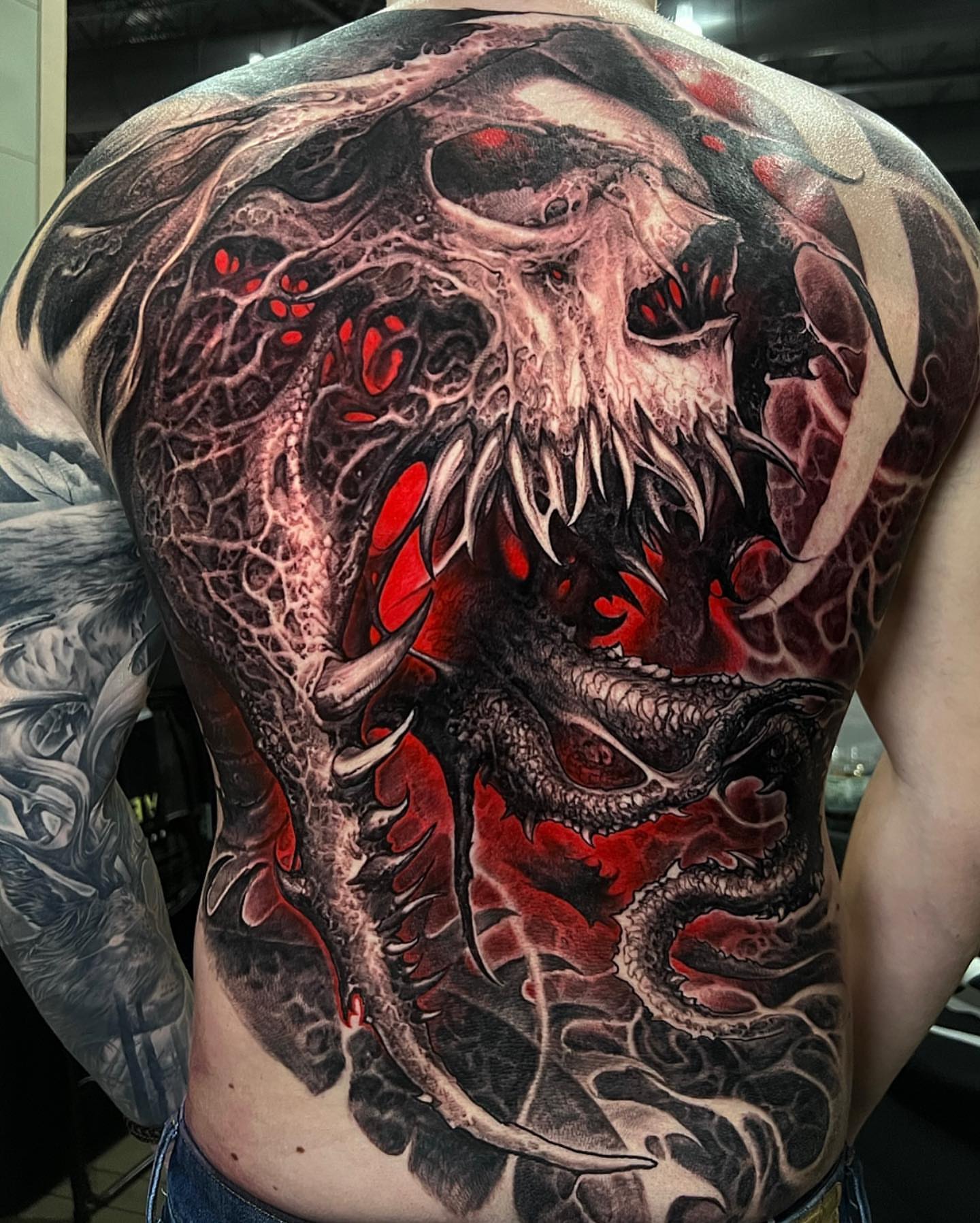 Dragon dark realism tattoo on the back by Brandon Herrera