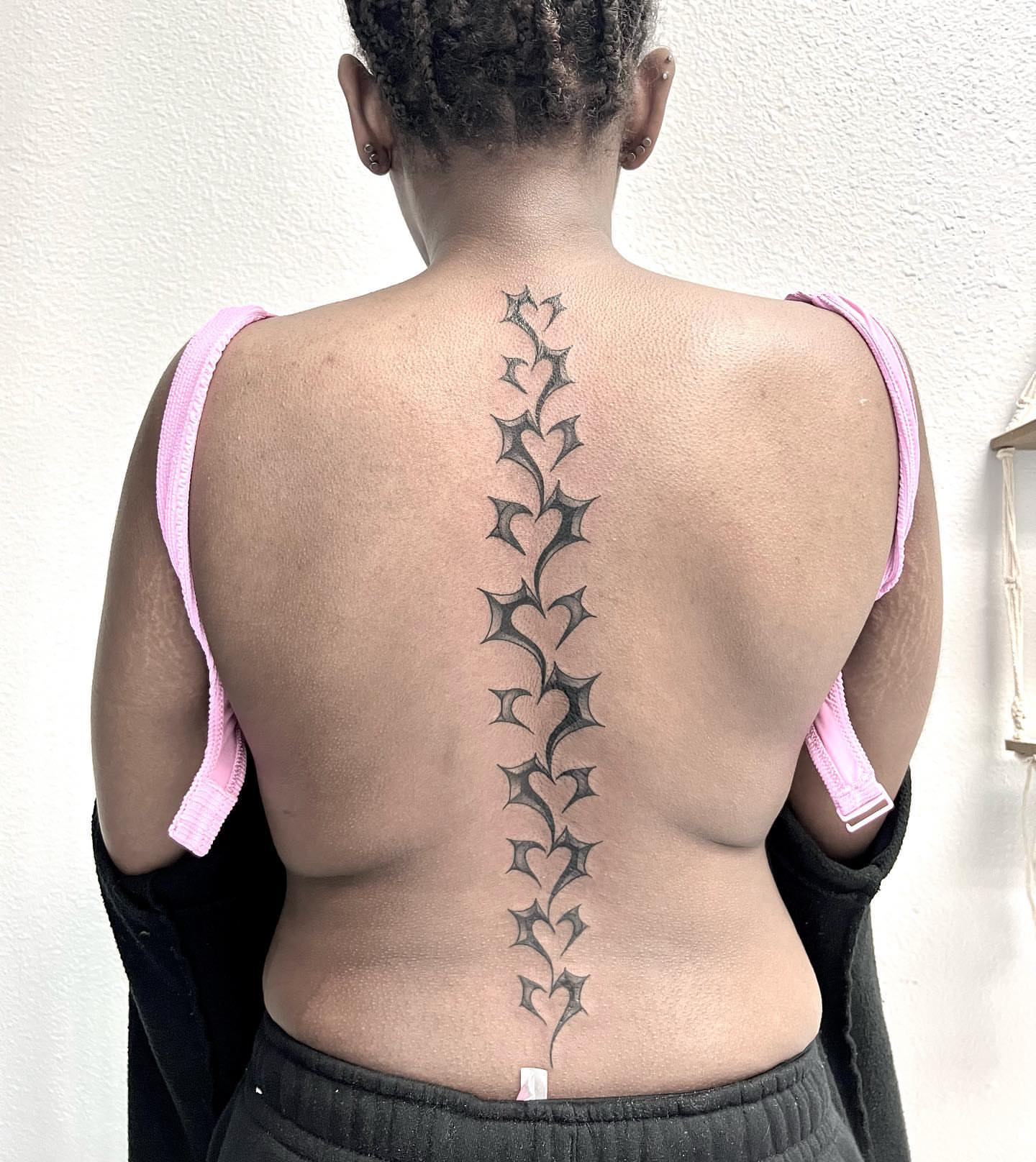 Spine black and grey tattoo on the back by Desirae✨