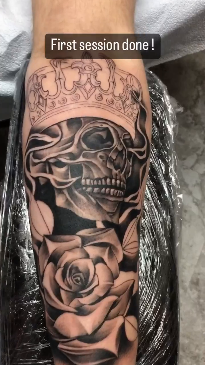 Skull and roses realism tattoo on the forearm by Cody Wolfe