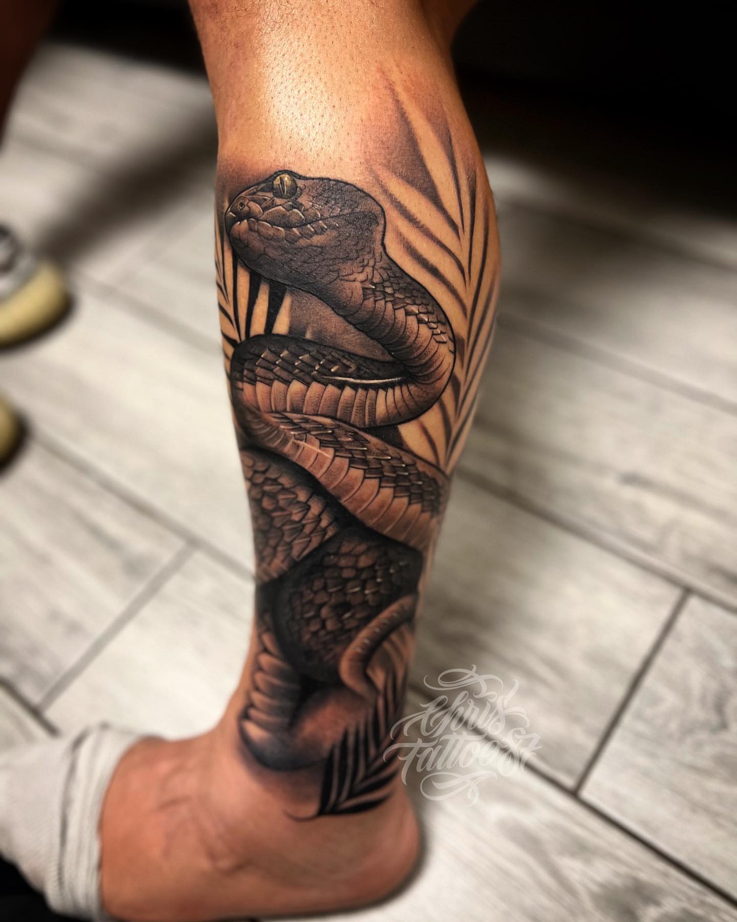 Snake realism tattoo on the calf by chris tattoo