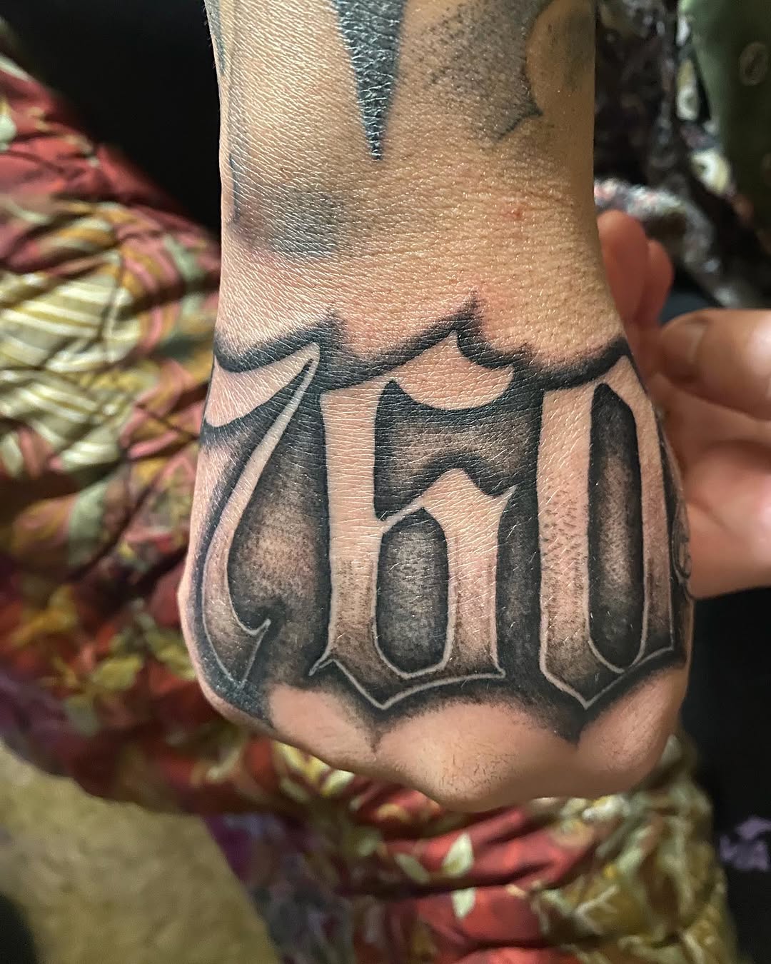 760 numbers Chicano tattoo on the hand by Ramirez Tattooing