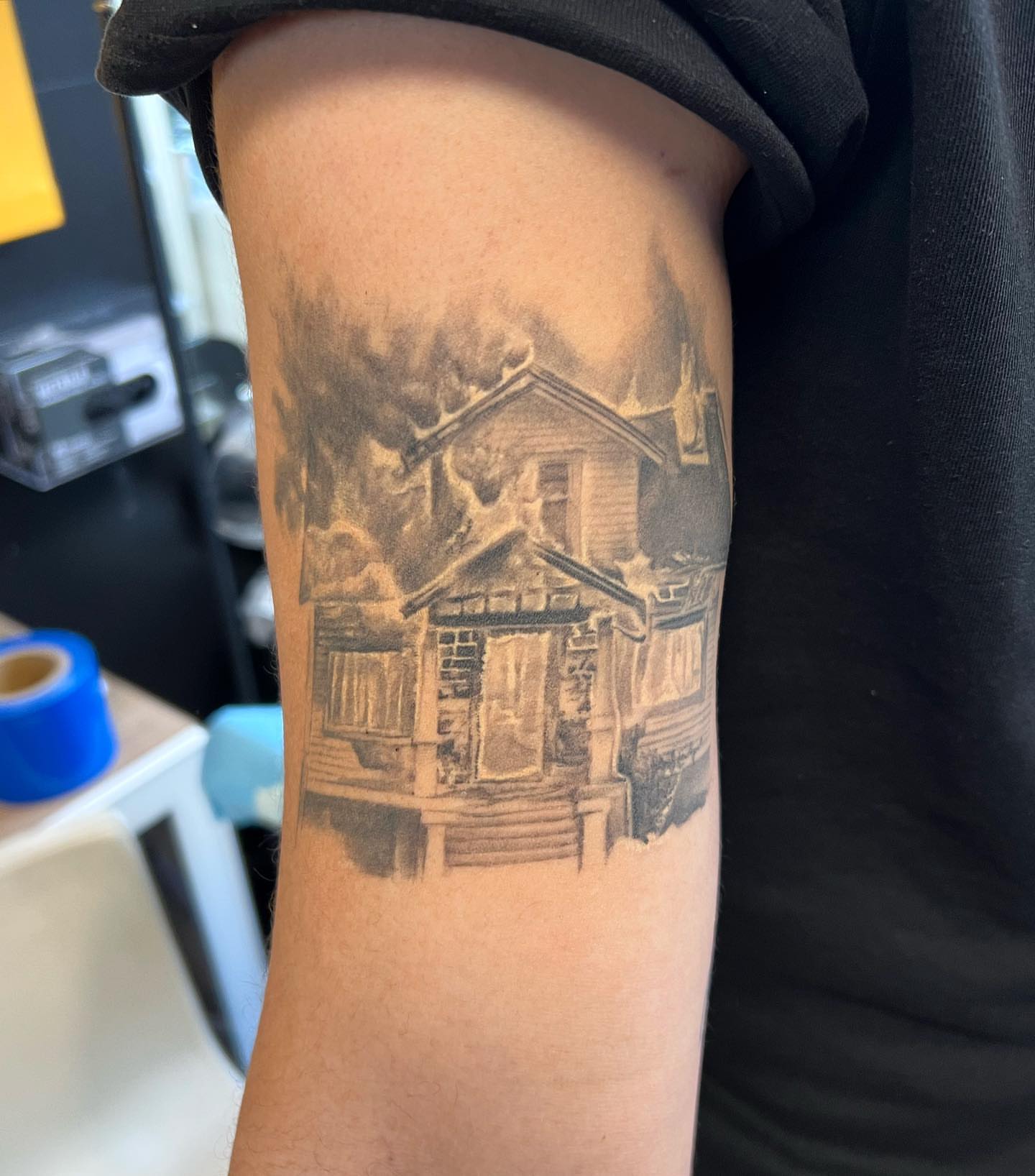 Burning house black and grey tattoo on the forearm by The Tattoo Saint- DMV Tattoo Artist, Hyattsville, Maryland