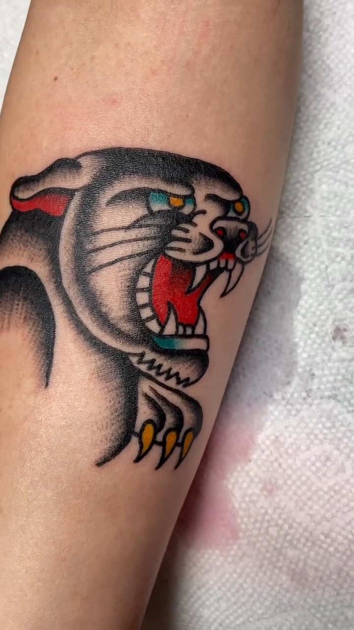 Panther head American traditional tattoo by Dorian Grey Baker