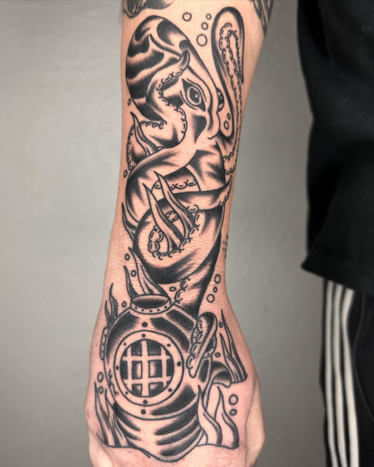 Octopus and diving helmet realism tattoo on the forearm by Elijah Edwards
