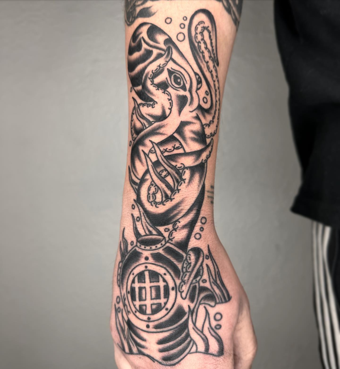 Octopus and diving helmet realism tattoo on the forearm by Elijah Edwards