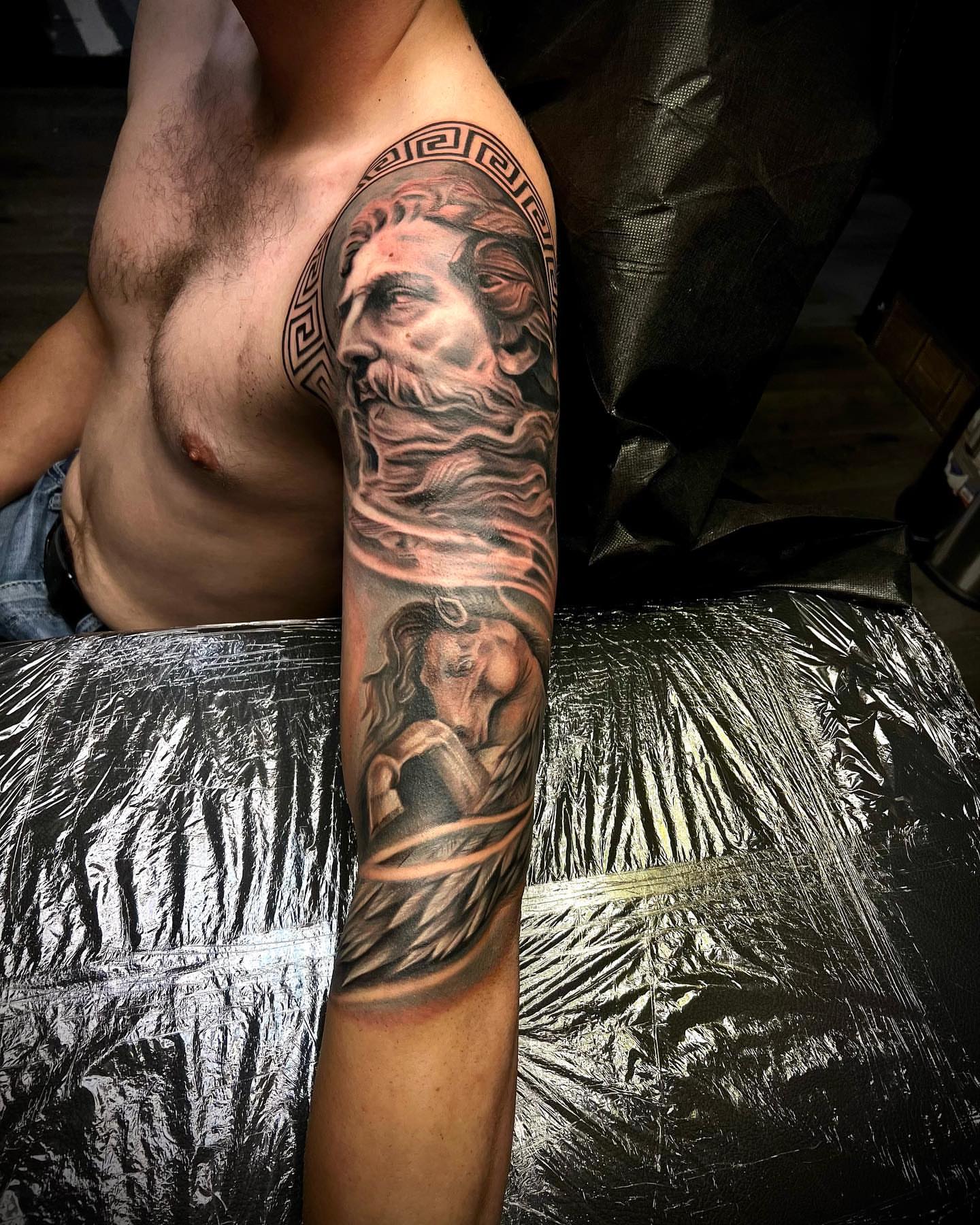 Bearded man with waves realism tattoo on the forearm by Levi Tattoo Artist, Utah