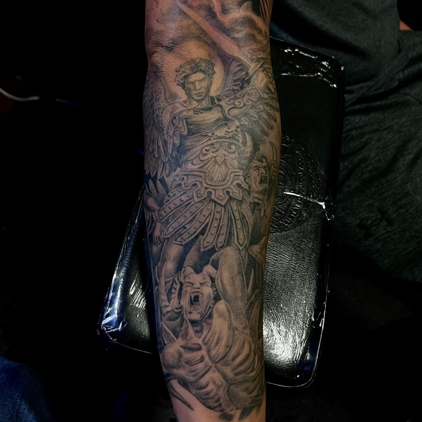 Angel and demon realism tattoo on the forearm by JT Ink