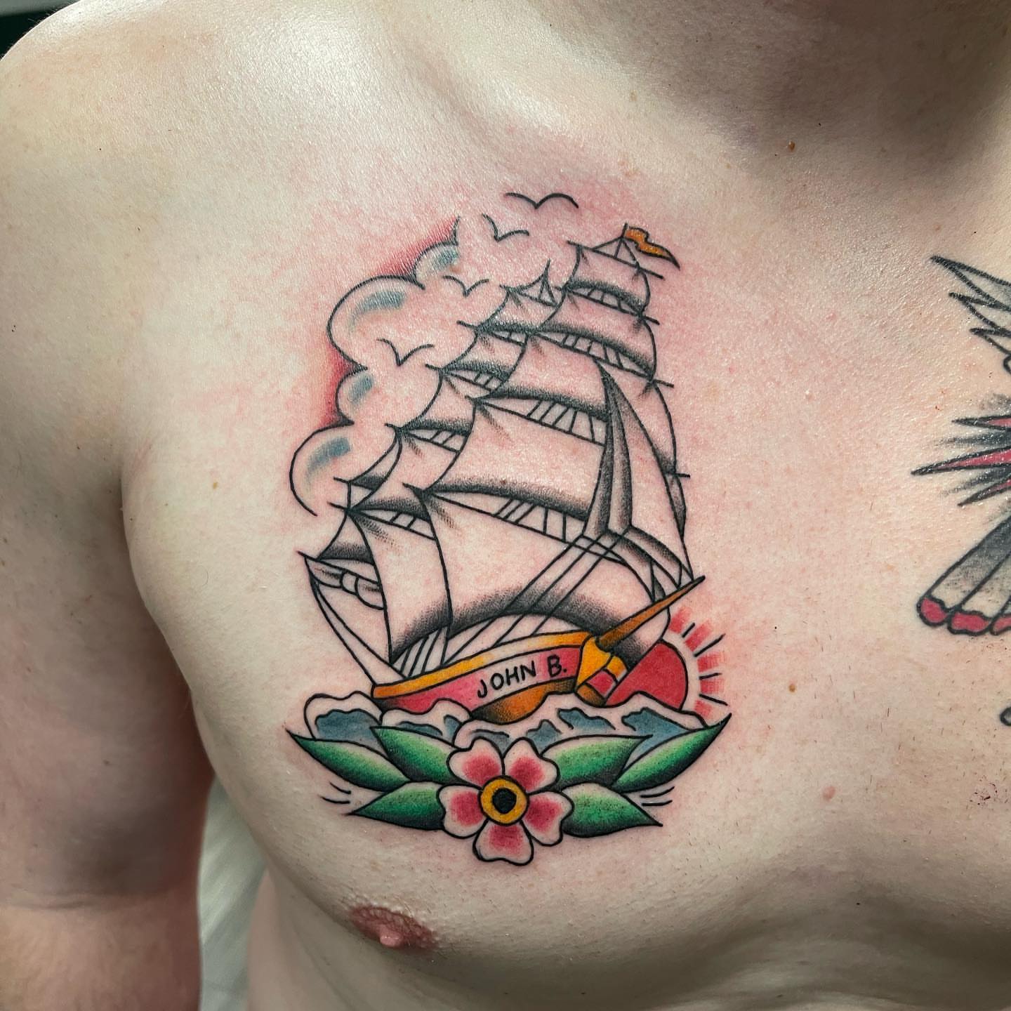 Ship and flower American traditional tattoo on the chest by Dave Shurman