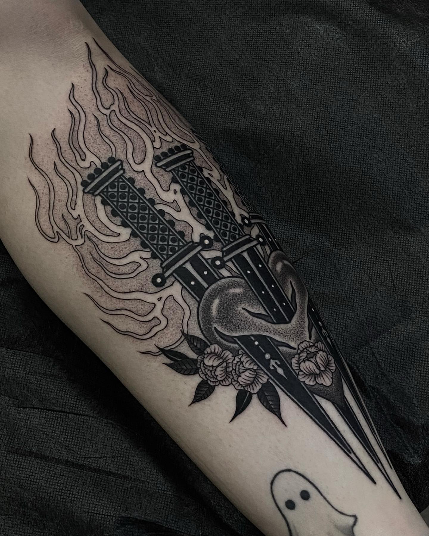 Flame and cross geometric tattoo on the forearm by Tyler Charles