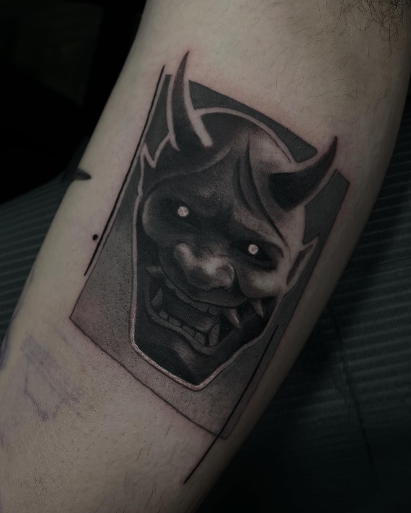 Demon head dark realism tattoo on the forearm by Madison Ast Tattoo