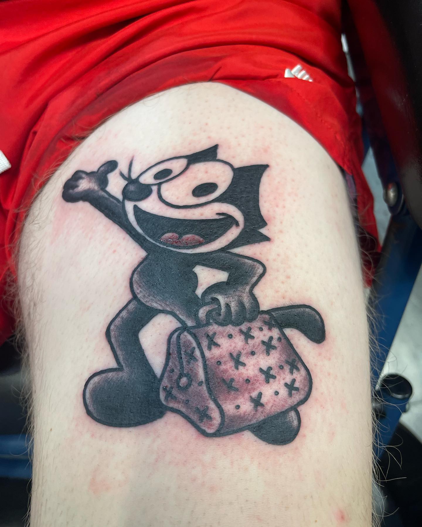 Felix the cat black and grey tattoo on the thigh by Edward Choat