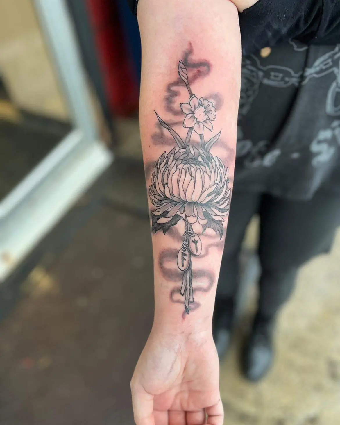 Chrysanthemum and key black and grey tattoo on the forearm by Perry