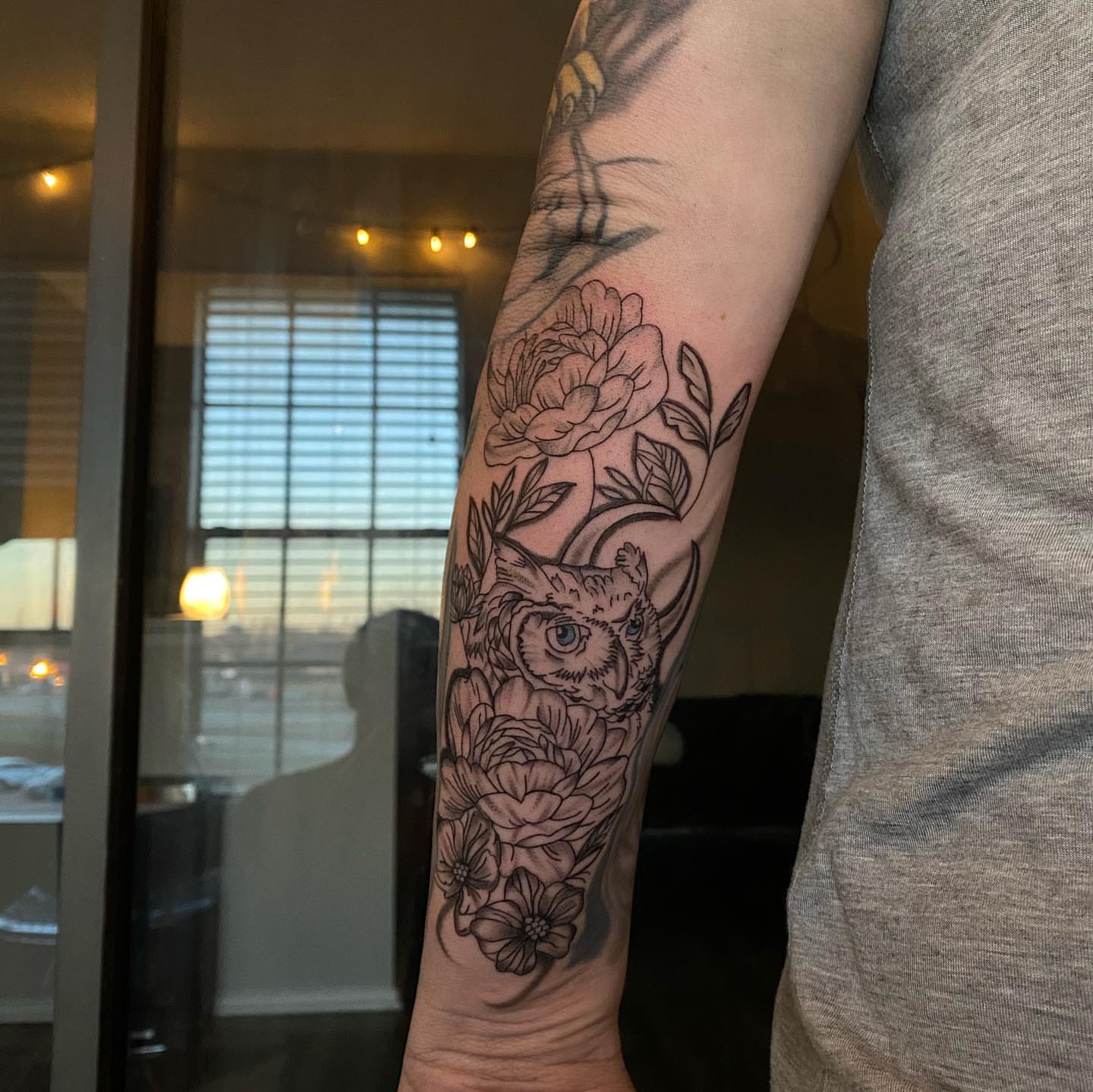 Owl and flowers black and grey tattoo on the forearm by @tattoosbyskyeee
