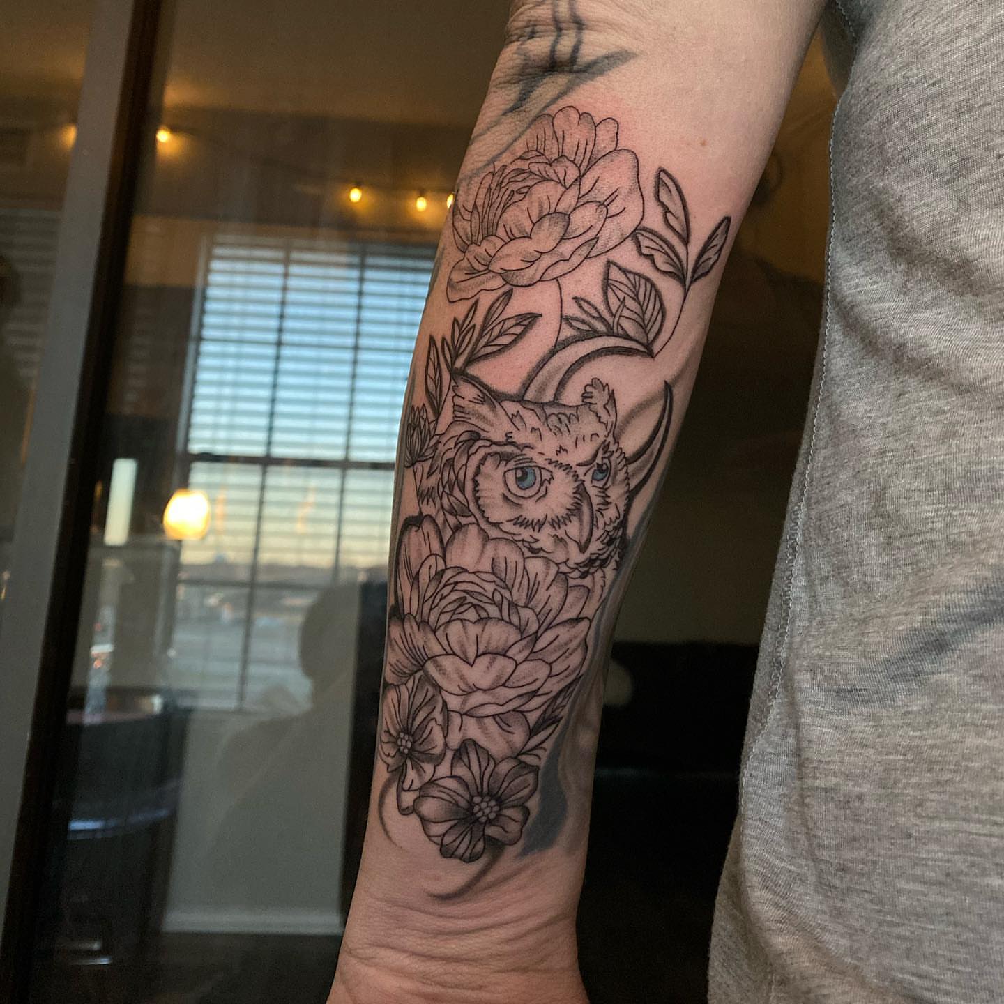 Owl and flowers black and grey tattoo on the forearm by @tattoosbyskyeee