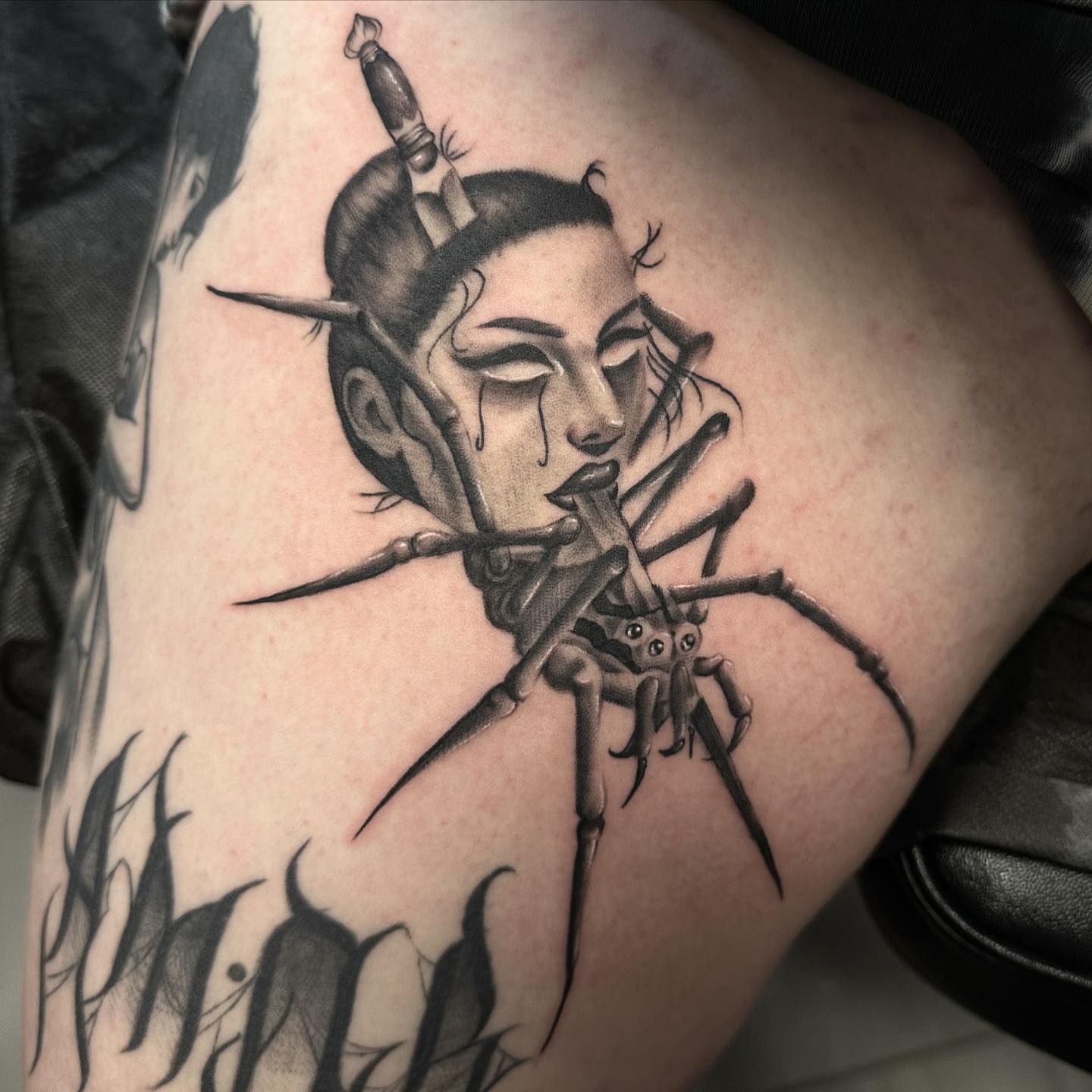 Woman with spider realism tattoo on the thigh by Tattoosxjoseph