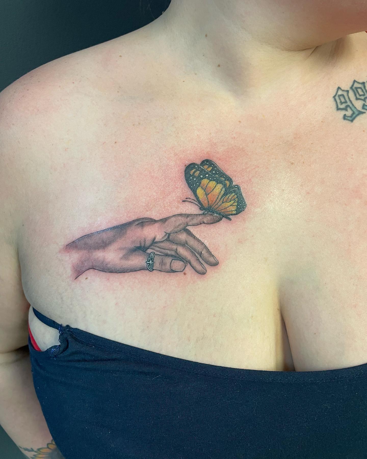 Butterfly on hand realism tattoo on the chest by Las Vegas Tattoo Artist